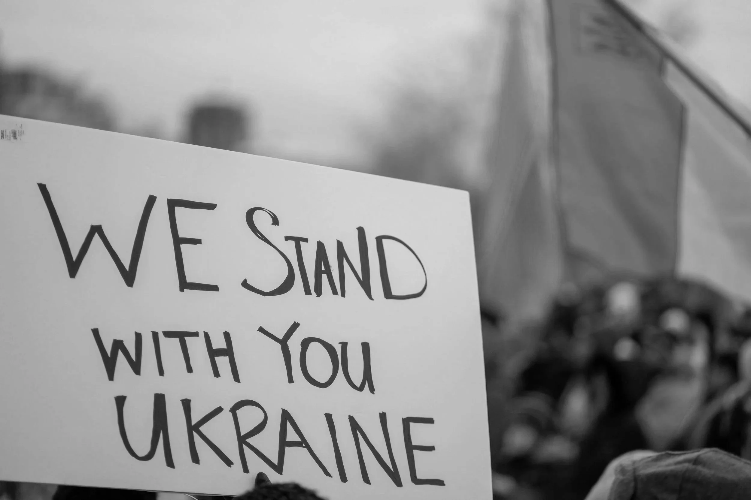 A protest sign that reads, 'WE STAND WITH YOU UKRAINE.'