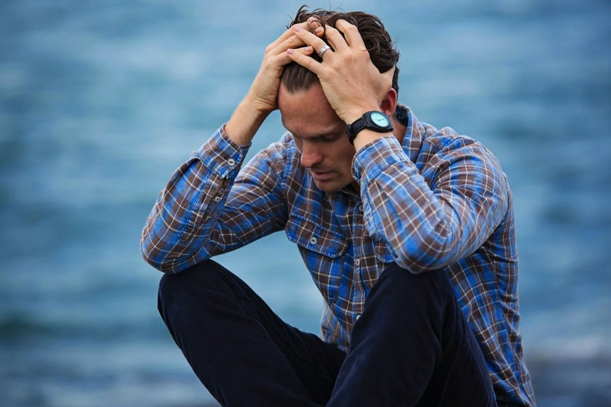 man with head in his hands