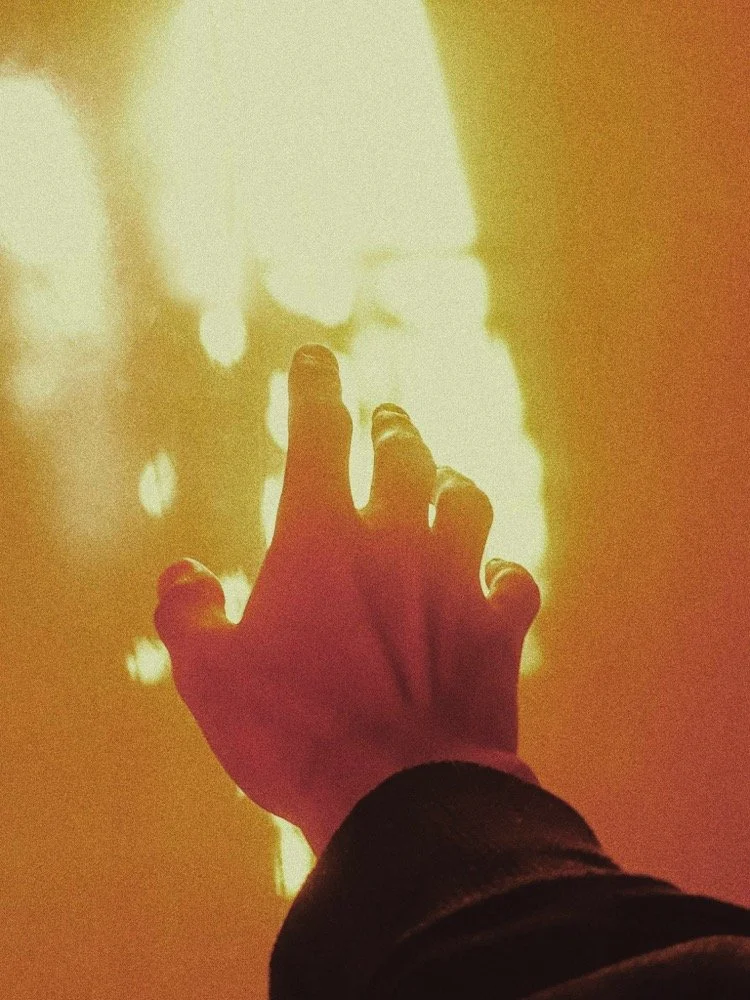 hand reaching towards the light