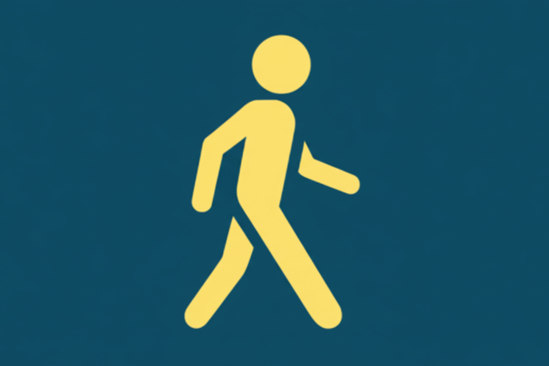 Pedestrian walking sign with yellow figure on blue background.
