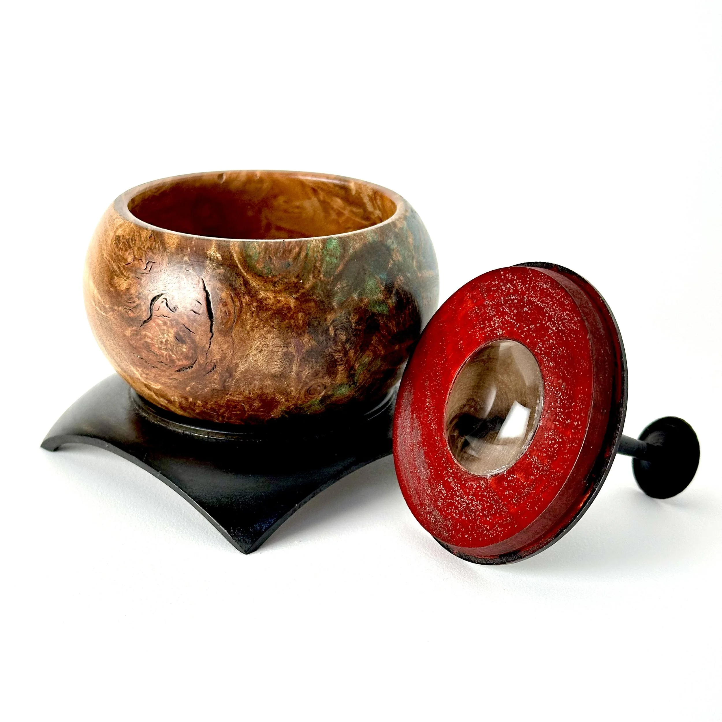Wooden bowl with lid on a black stand, isolated on white background.