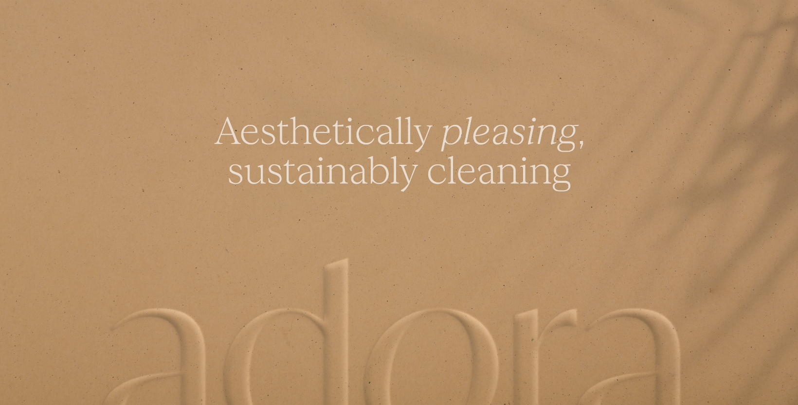 A beige background with the text 'Aesthetically pleasing, sustainably cleaning' and the faint outline of the word 'ador'.