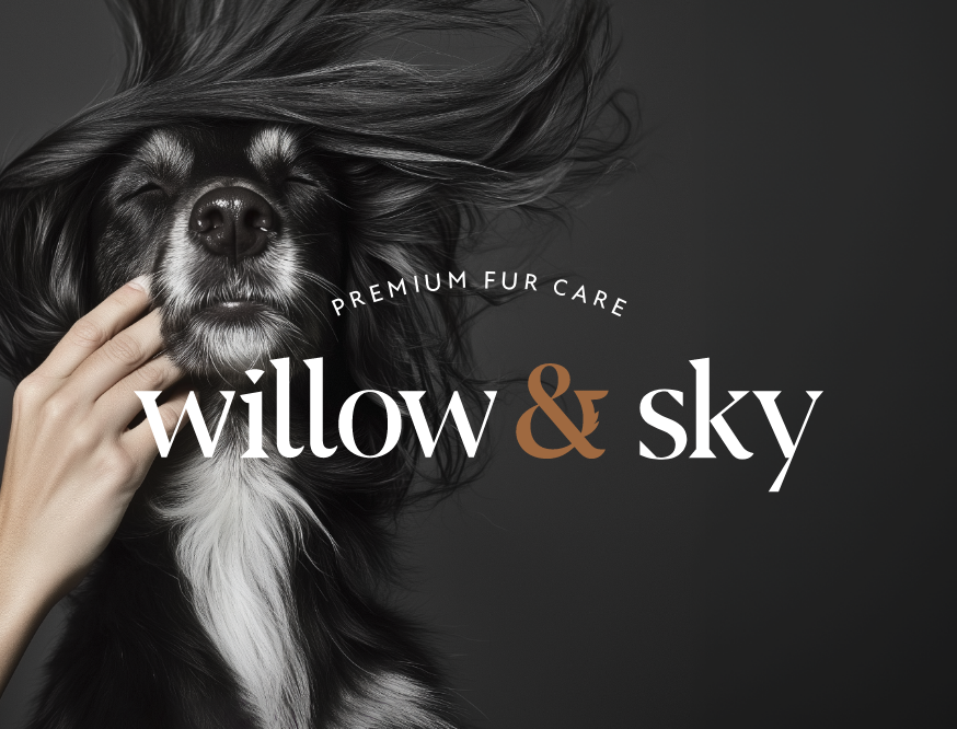 Close-up of a black and white dog with long fur, eyes closed, and a human hand touching its face, with a dark background and text reading 'Premium Fur Care Willow & Sky'.