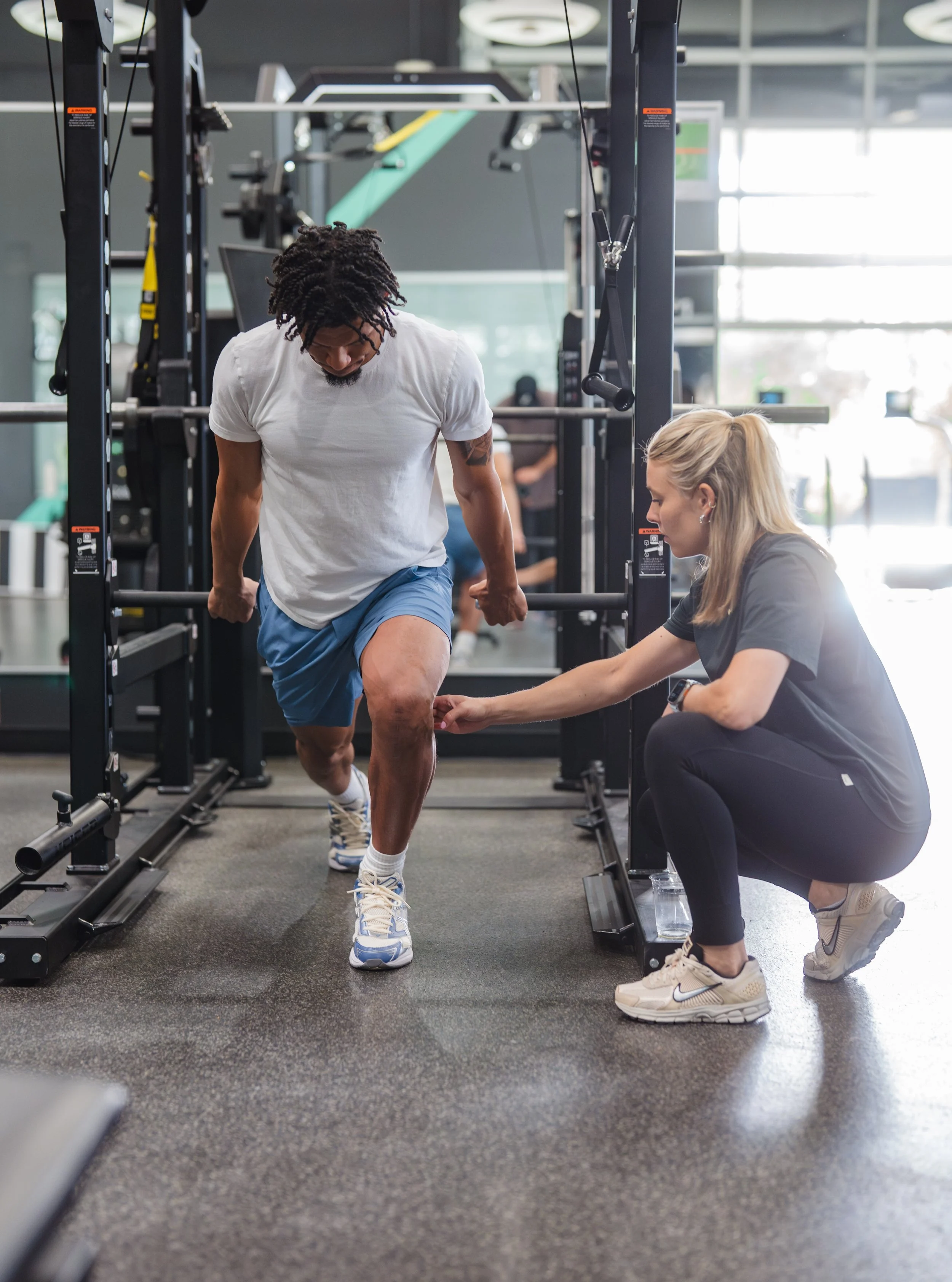 Abigail Pellett working with NFL combine athlete cueing proper lunge positioning.