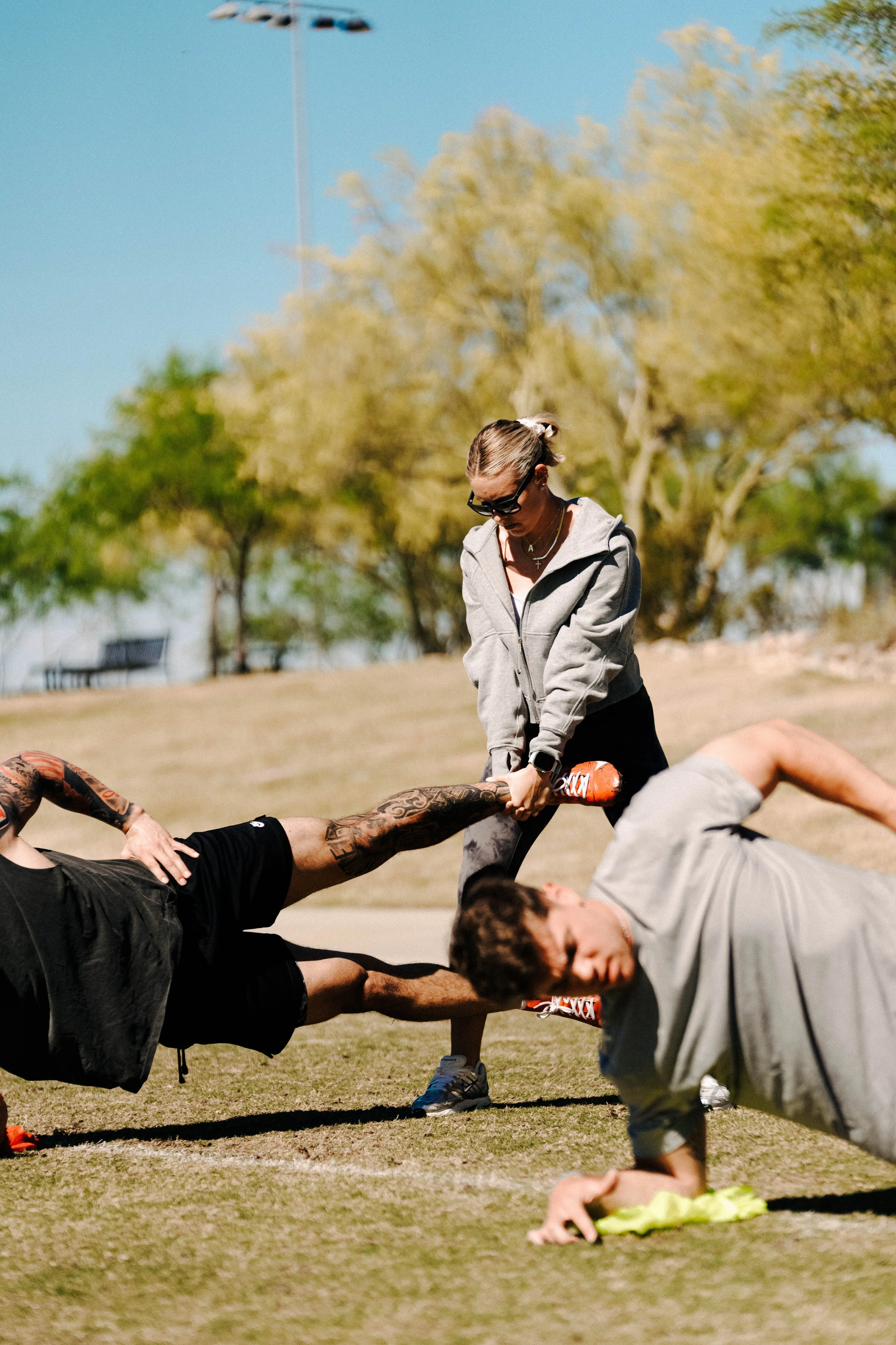Abigal Pellett working with athletes as they recover from injury and return to performance in a field setting.