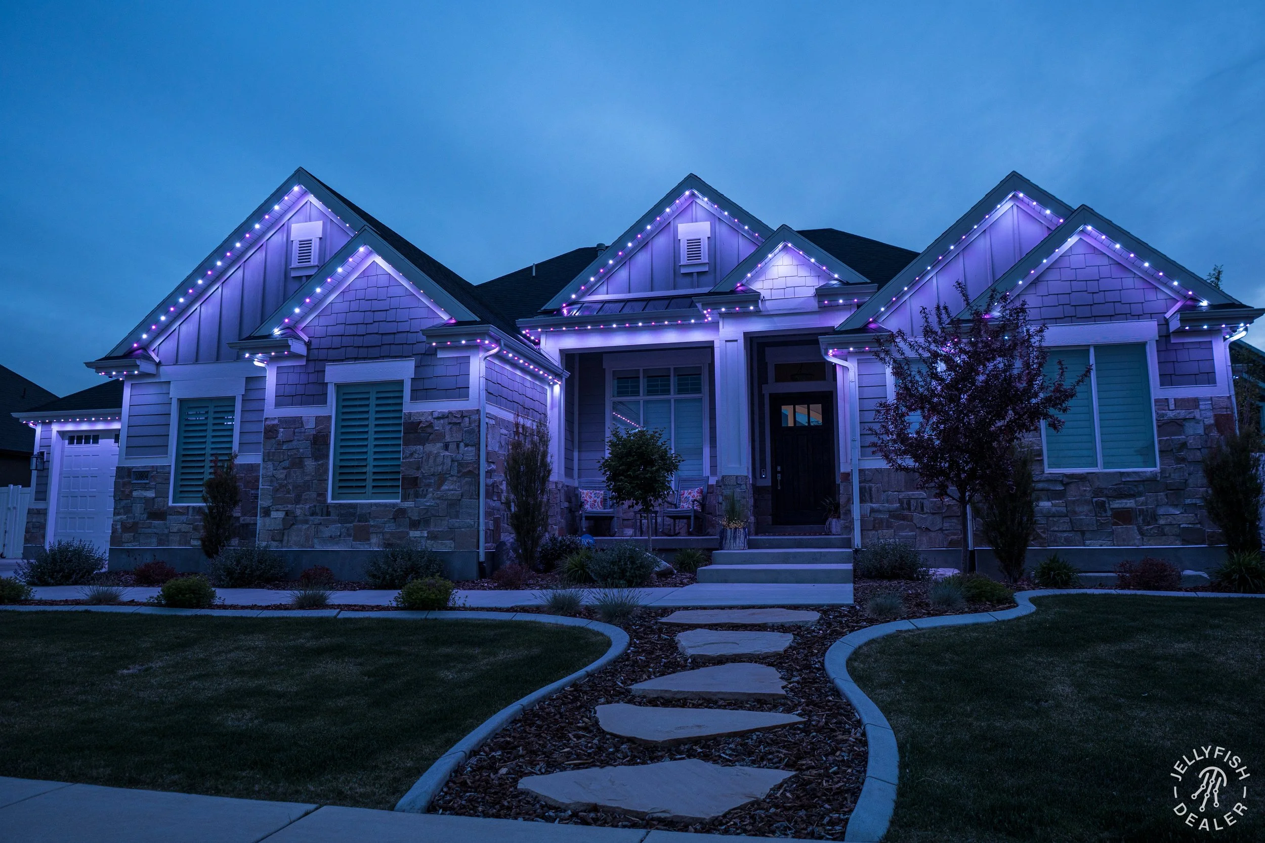 Custom permanent track installation featuring rich twilight presets to complement natural stone architecture.