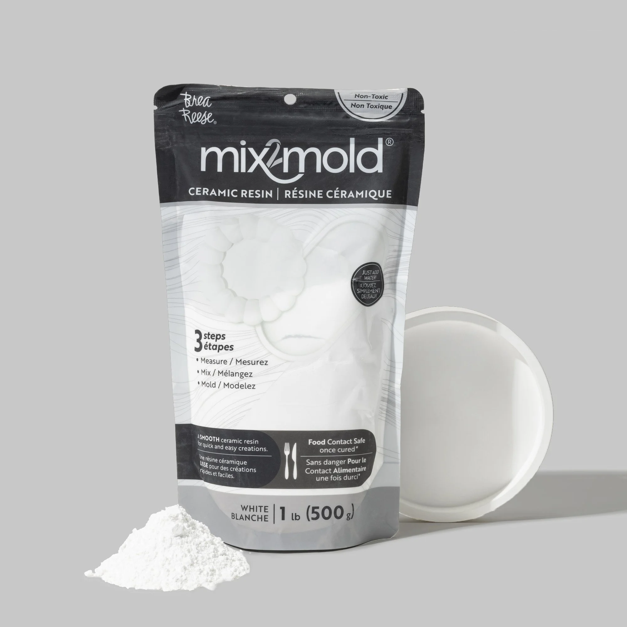Package of Mix2mold ceramic resin, with a mound of white resin powder in front and a container of liquid resin in the background.