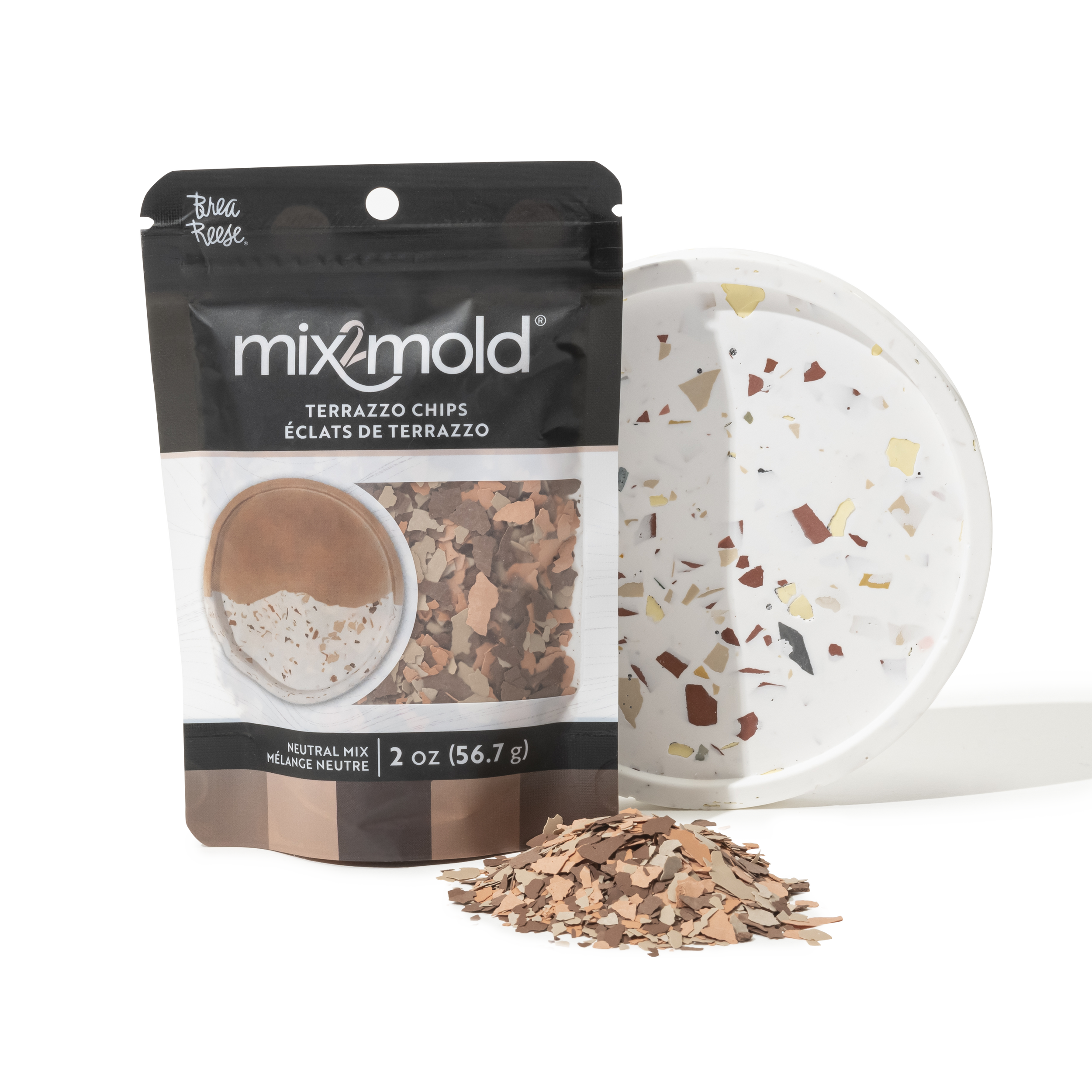 Package of mixmold terrazzo chips next to a terrazzo tray with scattered chips.