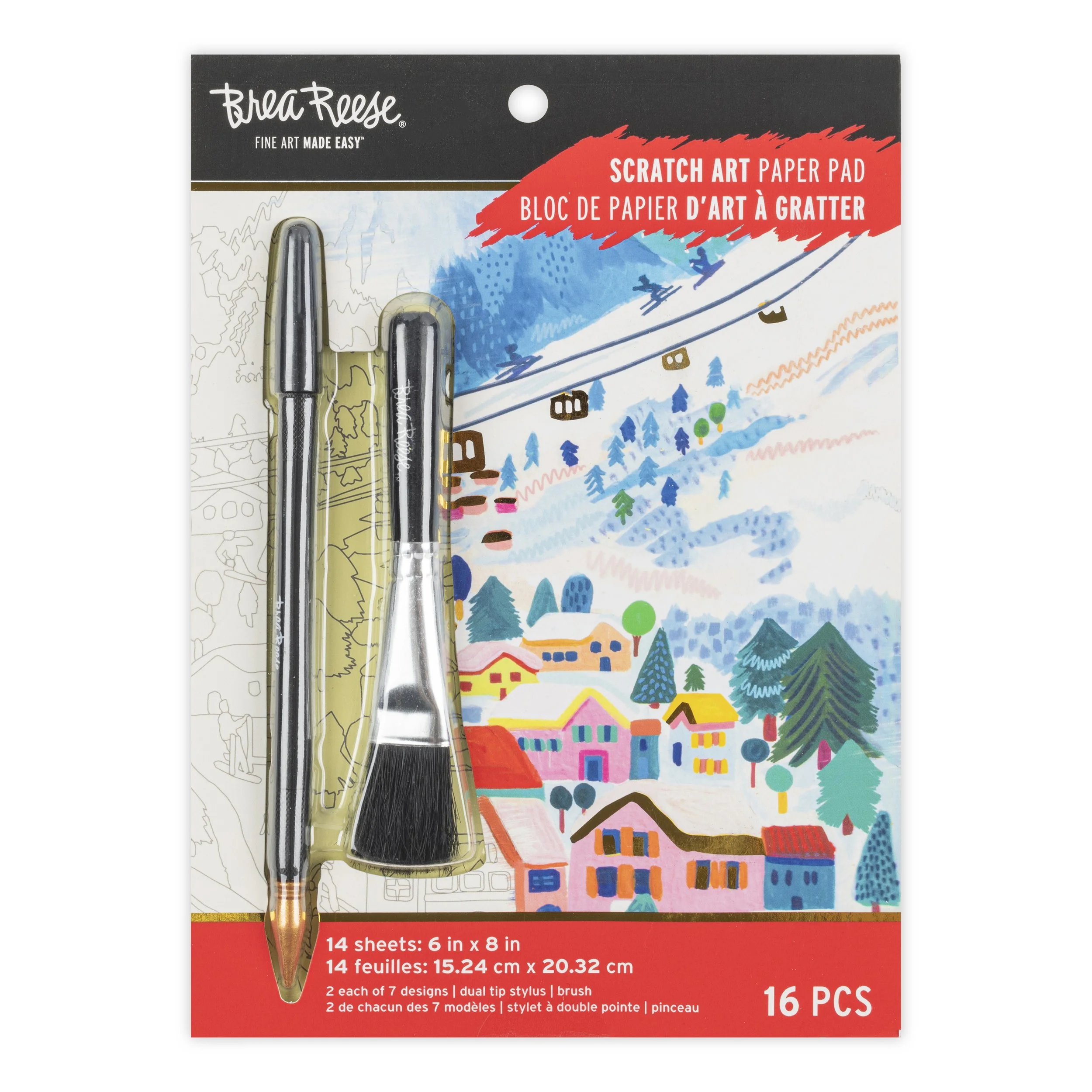 Scratch art paper pad with two stylus tools in front of colorful illustrated mountain village scene.
