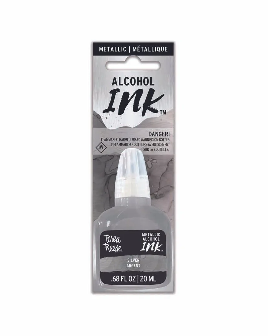Bottle of metallic alcohol ink with a silver color, labeled Breac Reese, 20 milliliters, flammable warning, in packaging.