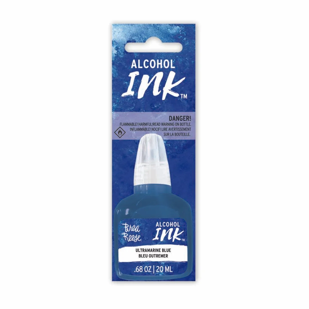 A bottle of Alcohol Ink in ultramarine blue color with cap, labeled Brah Rose, 20 ml, in blue packaging with warning about flammability.