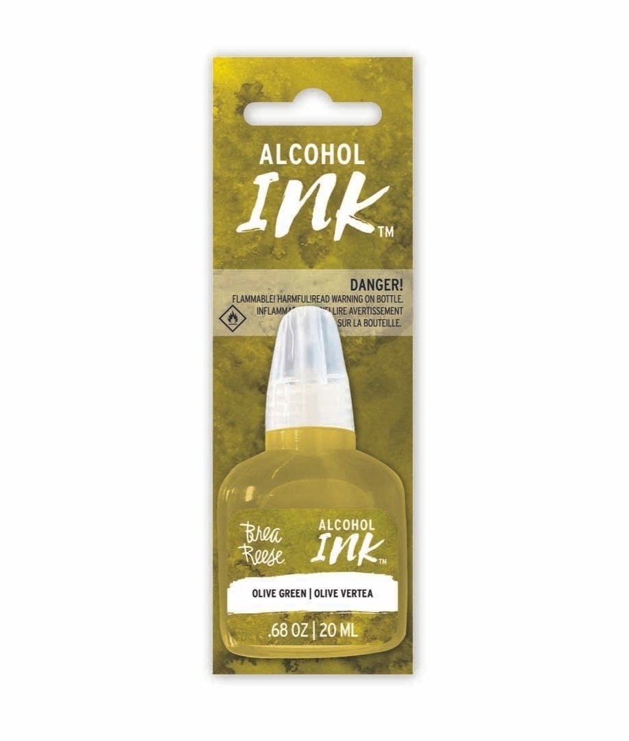 A bottle of Alcohol Ink in Olive Green color by Brea Reese, with a warning label on the packaging.