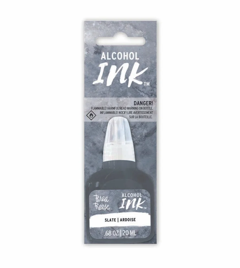 Packaging for alcohol-based ink in a black bottle with a transparent cap, labeled with the color 'Slate / Ardoise', volume of 0.68 ounces or 20 milliliters, with a warning about flammability and harmful fumes.