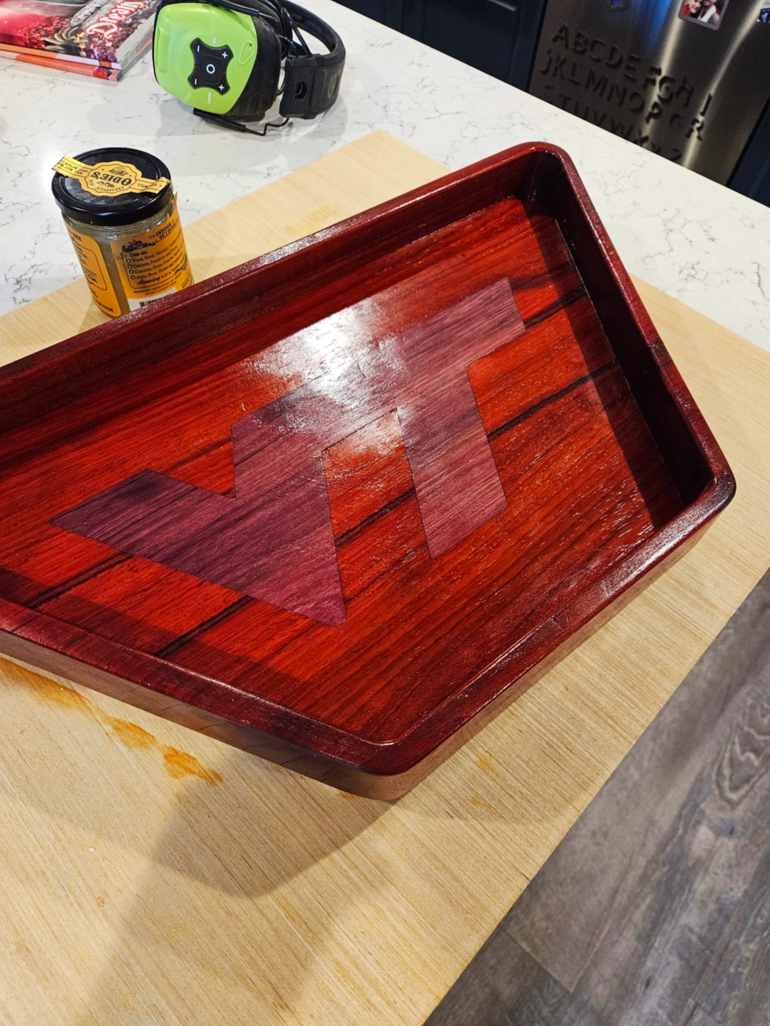 A maroon & orange wooden serving tray with the Virginia Tech logo inlaid into the center.