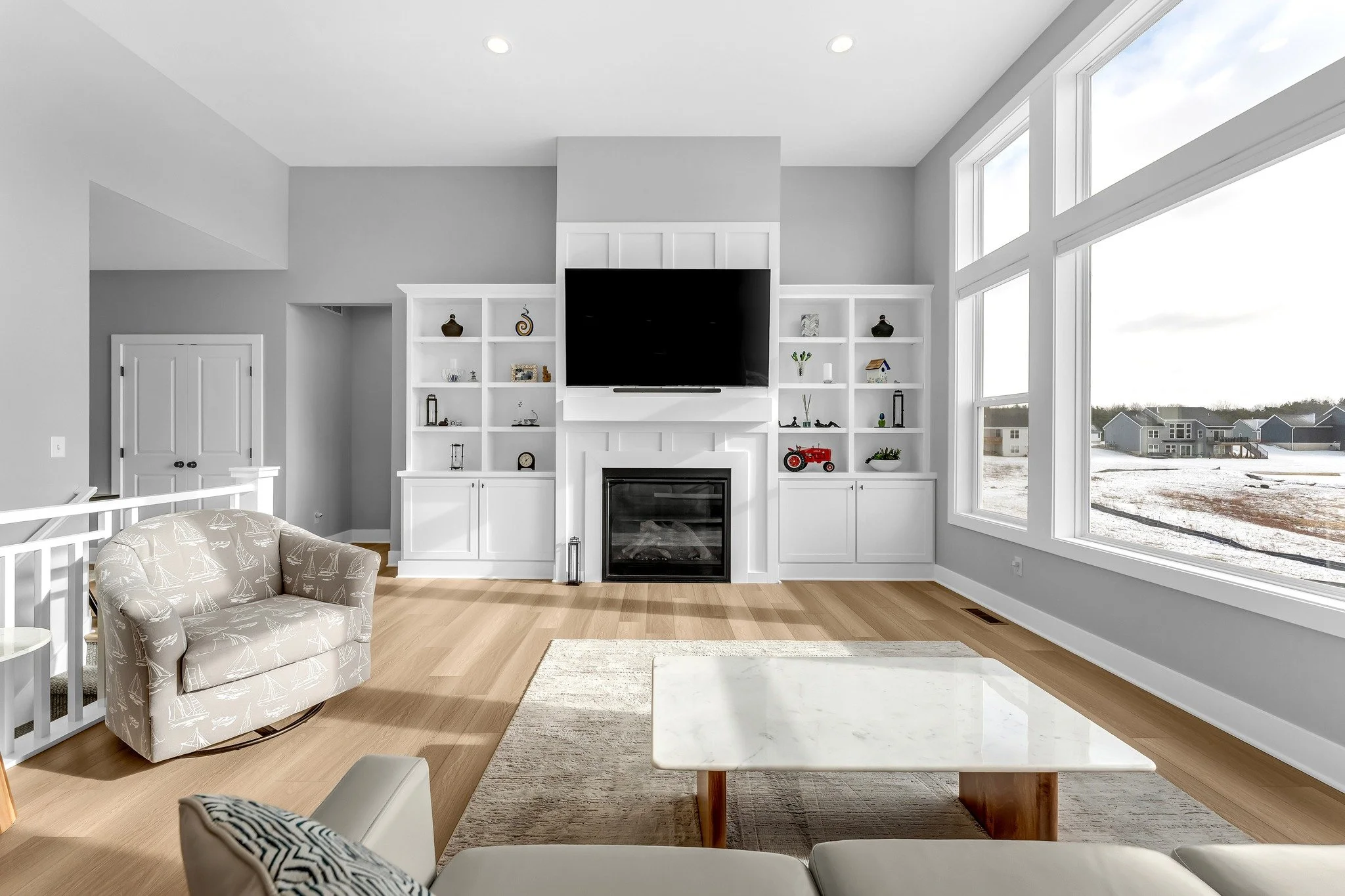 Discover this stunning ranch home built in 2024! 

Enjoy peaceful views of a 17-acre pond from the open-concept living area with 12ft ceilings, gas fireplace, and custom built-ins. 

The kitchen features modern white cabinetry, stainless steel applia