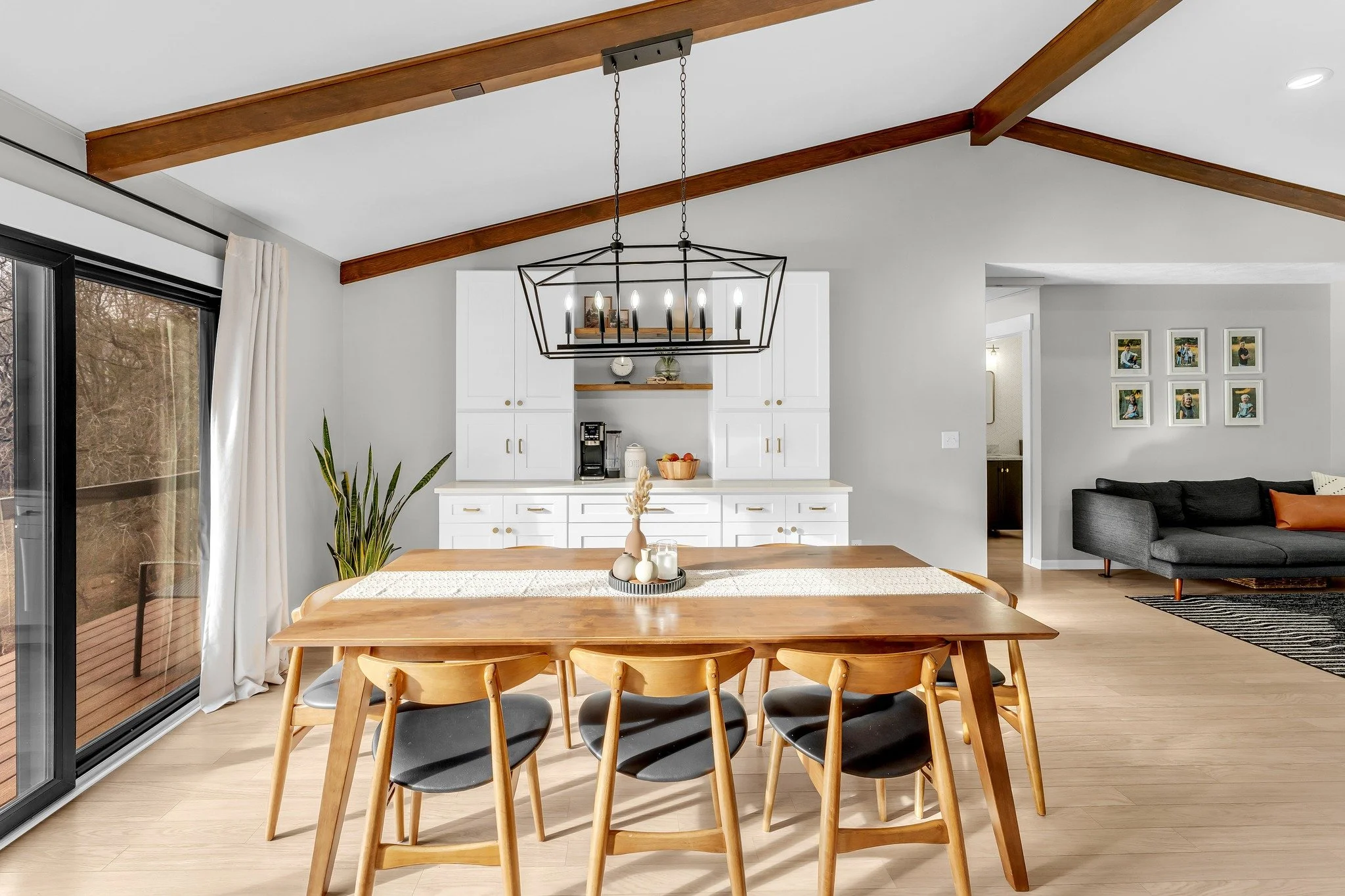 There is something so satisfying about a perfectly balanced photo. The sun rays streaming in through the window, the vaulted ceiling with wood beams, the metal chandelier, everything is just right!