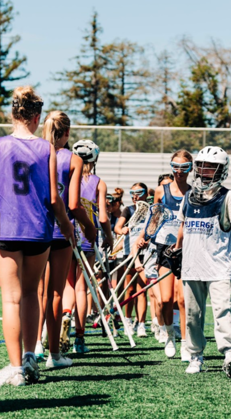 Girls lacrosse players competing in an Olympic-style Super 6s tournament game at a Tenacity Sixes event in the Bay Area