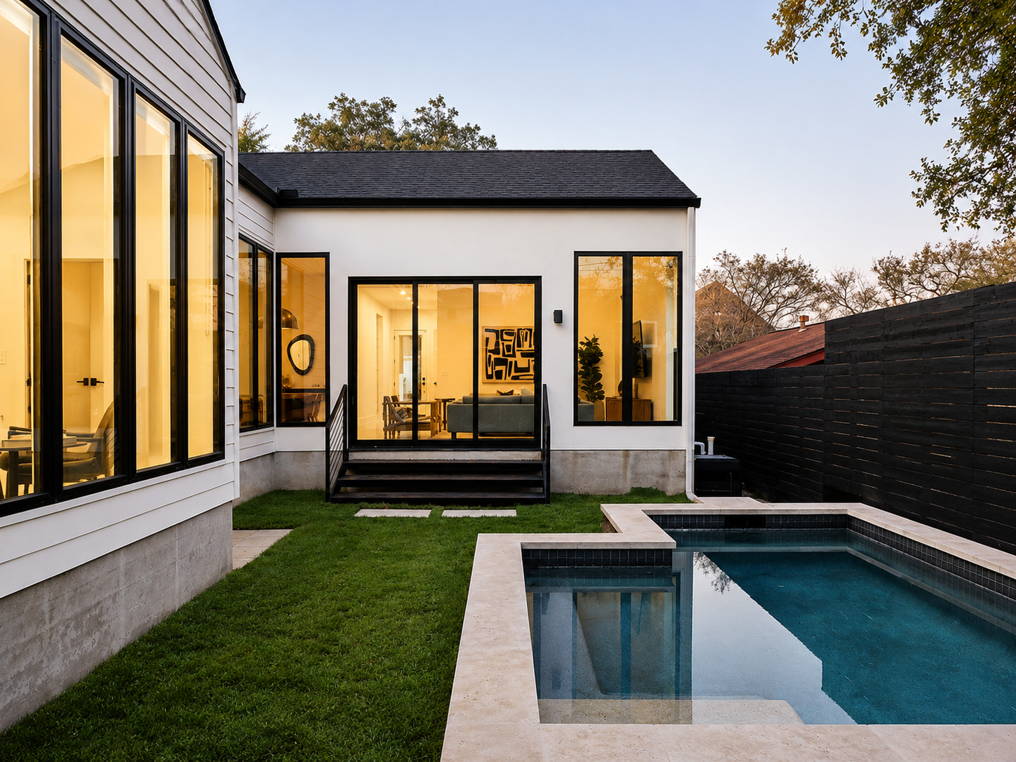 Anita St. backyard with pool at dusk.png