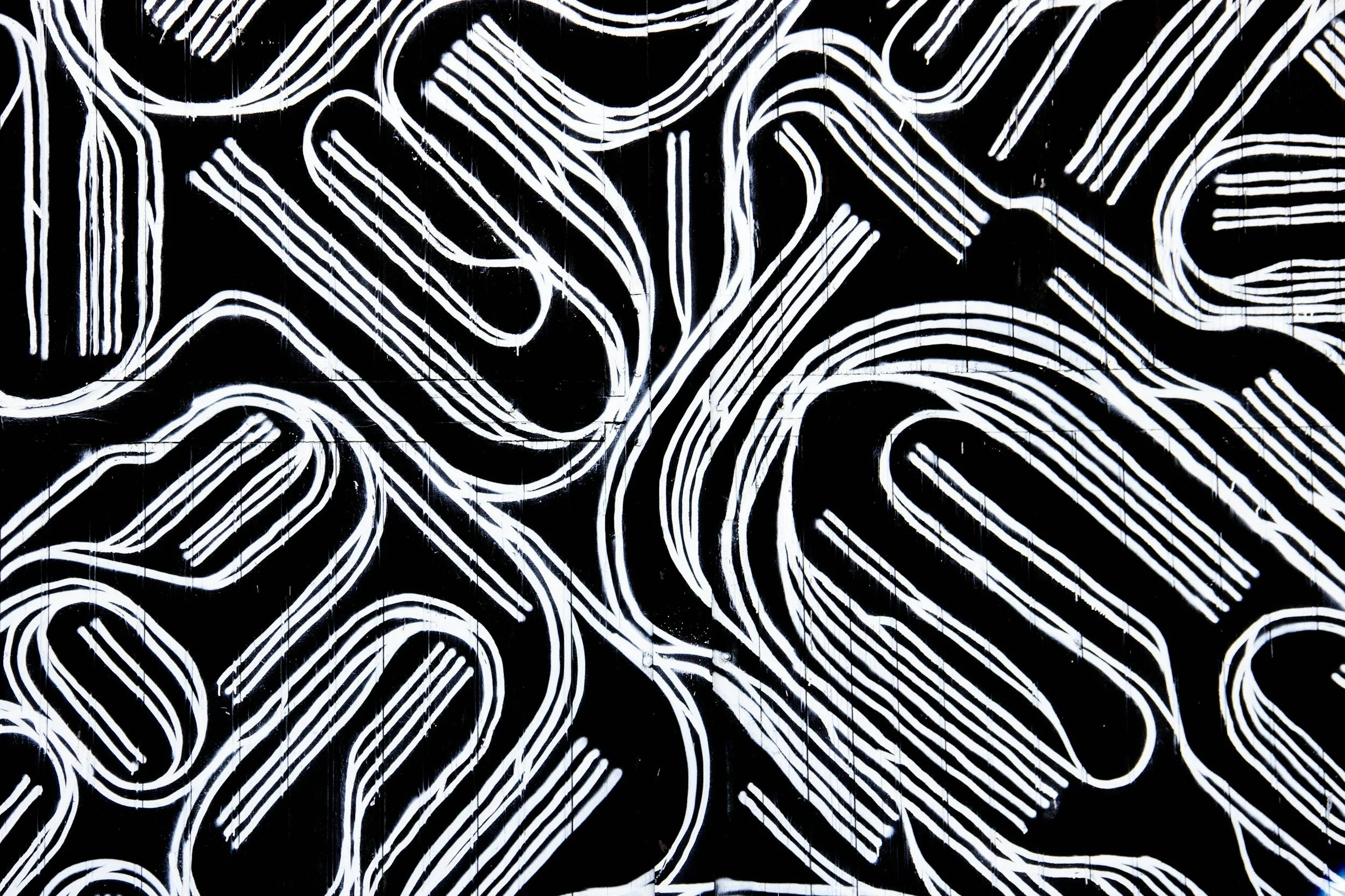 Black background with white neon-style abstract line art creating complex interconnected shapes.