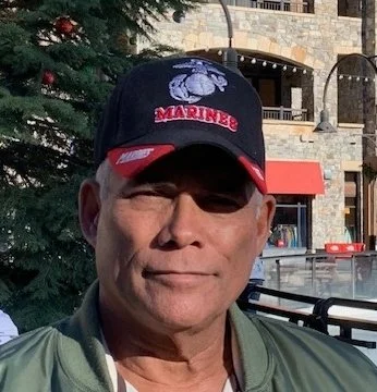 Rick Eaton, co-owner of Real Estate In Nevada LLC, Broker & co-owner, a retired federallaw enforcement executive, wearing a Marine Corps cap.