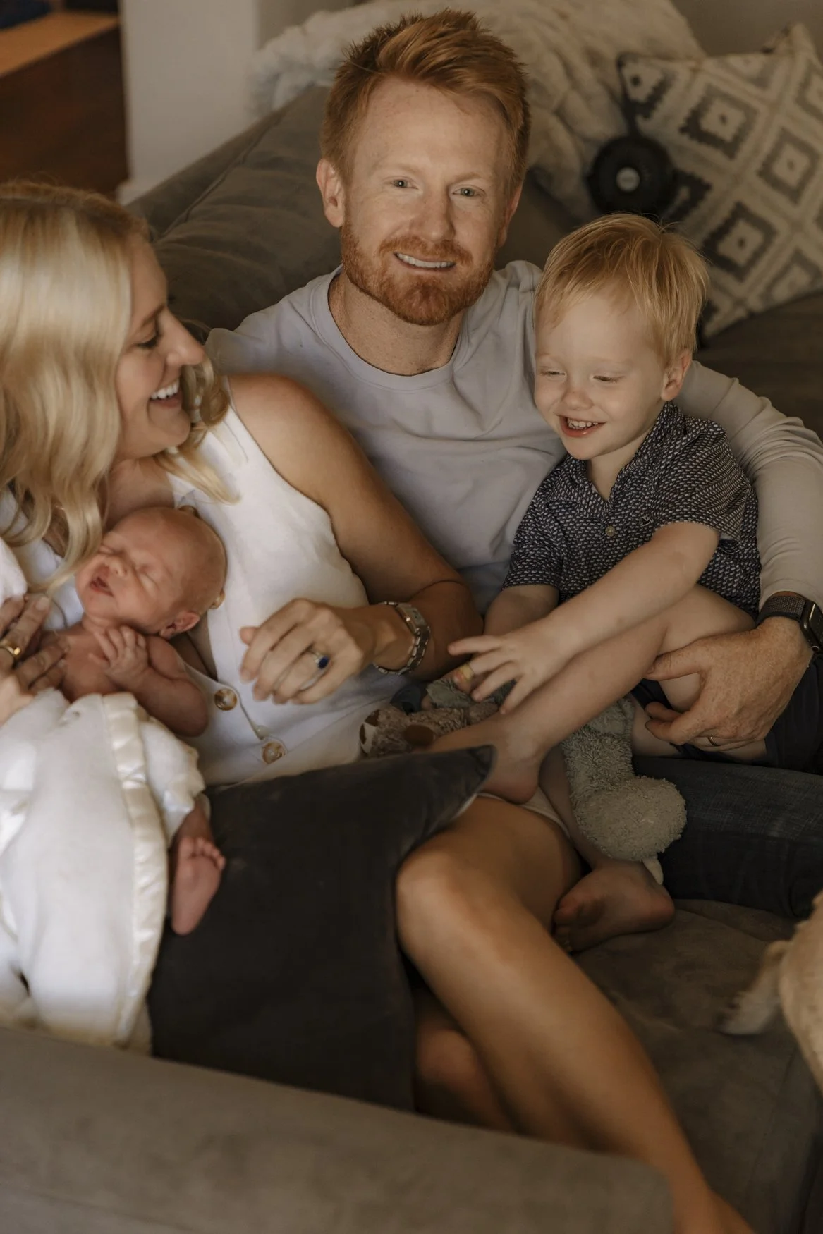 Orange County newborn photographer capturing a family together with a new baby, parents and siblings