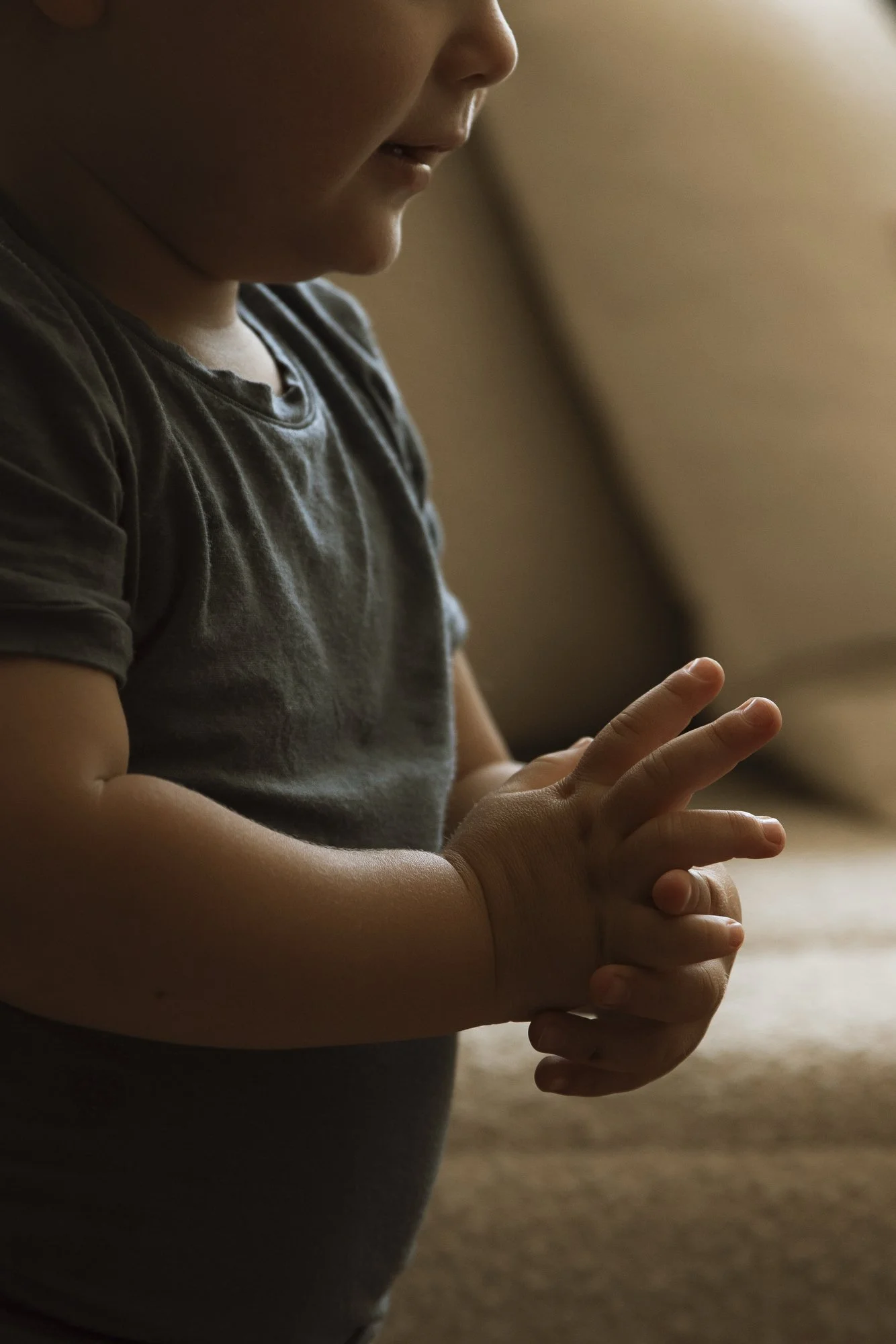 In-home family photography session in Los Angeles with details of baby's hands with natural light