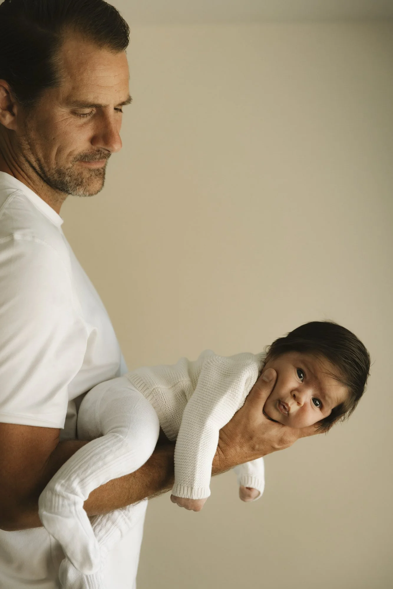 Documentary style family photography in Los Angeles focusing on details between father and baby