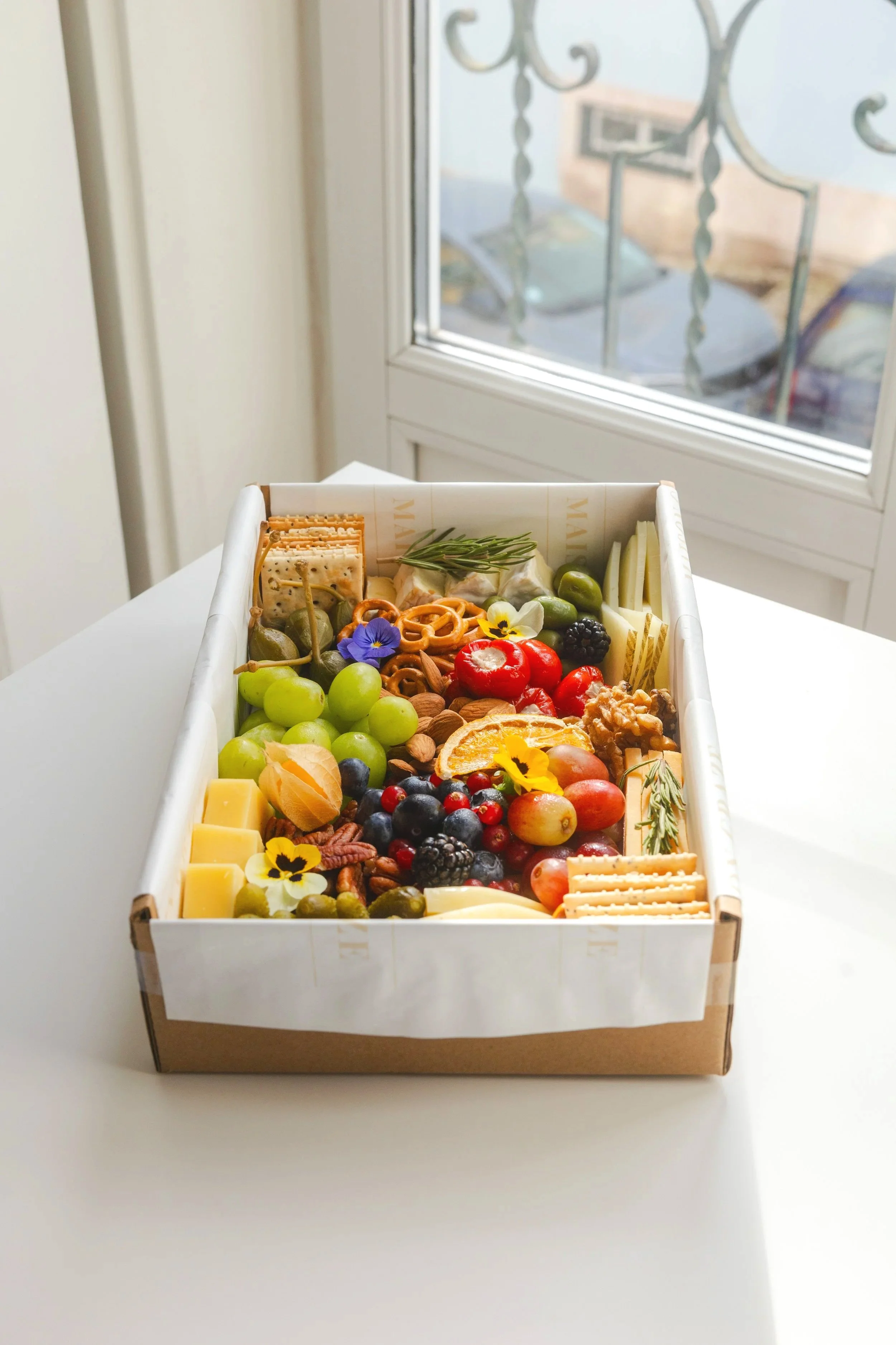 Maison Graze grazing box with premium cheeses and seasonal details