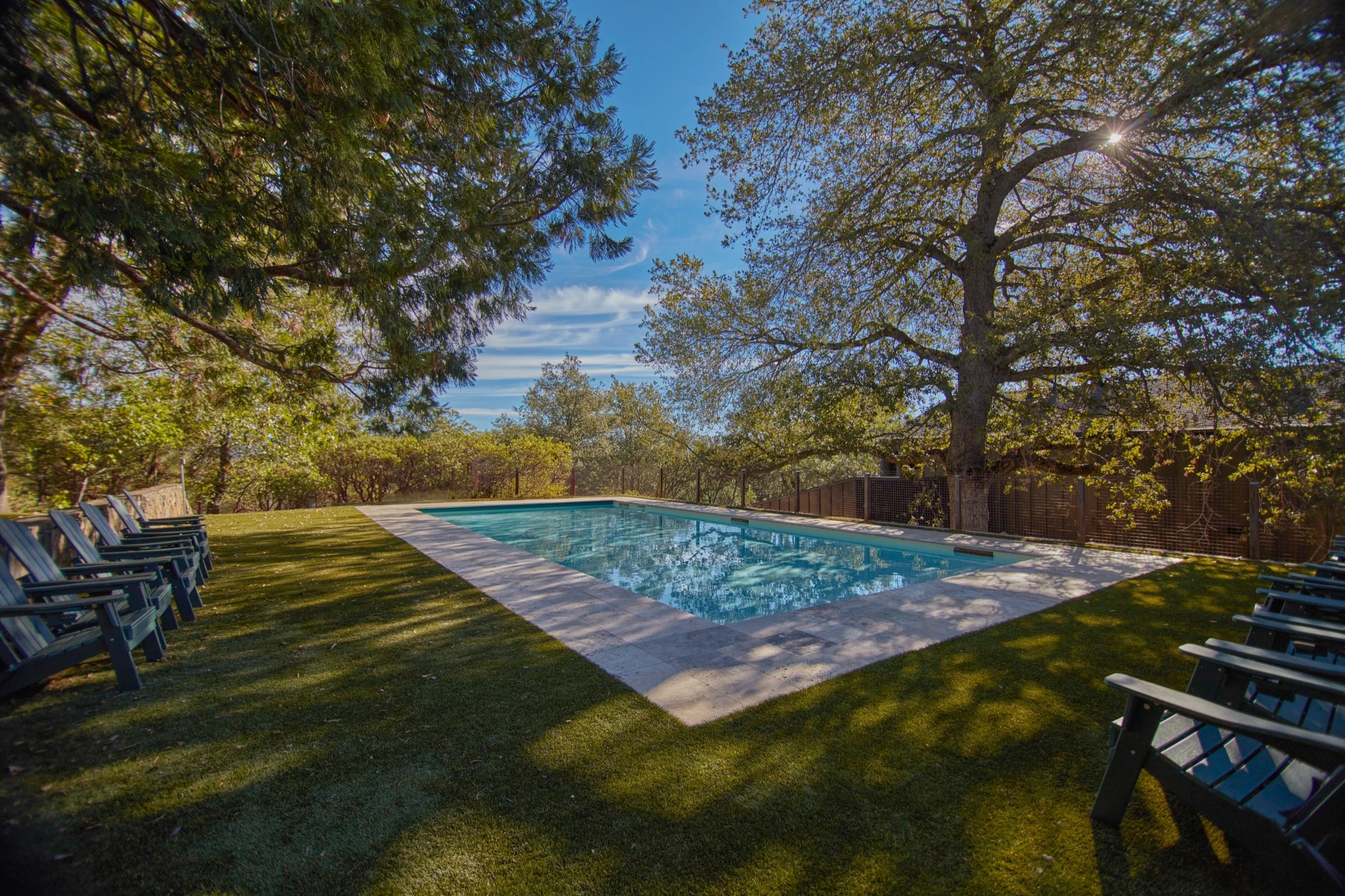 The pool and lawn in late afternoon light.