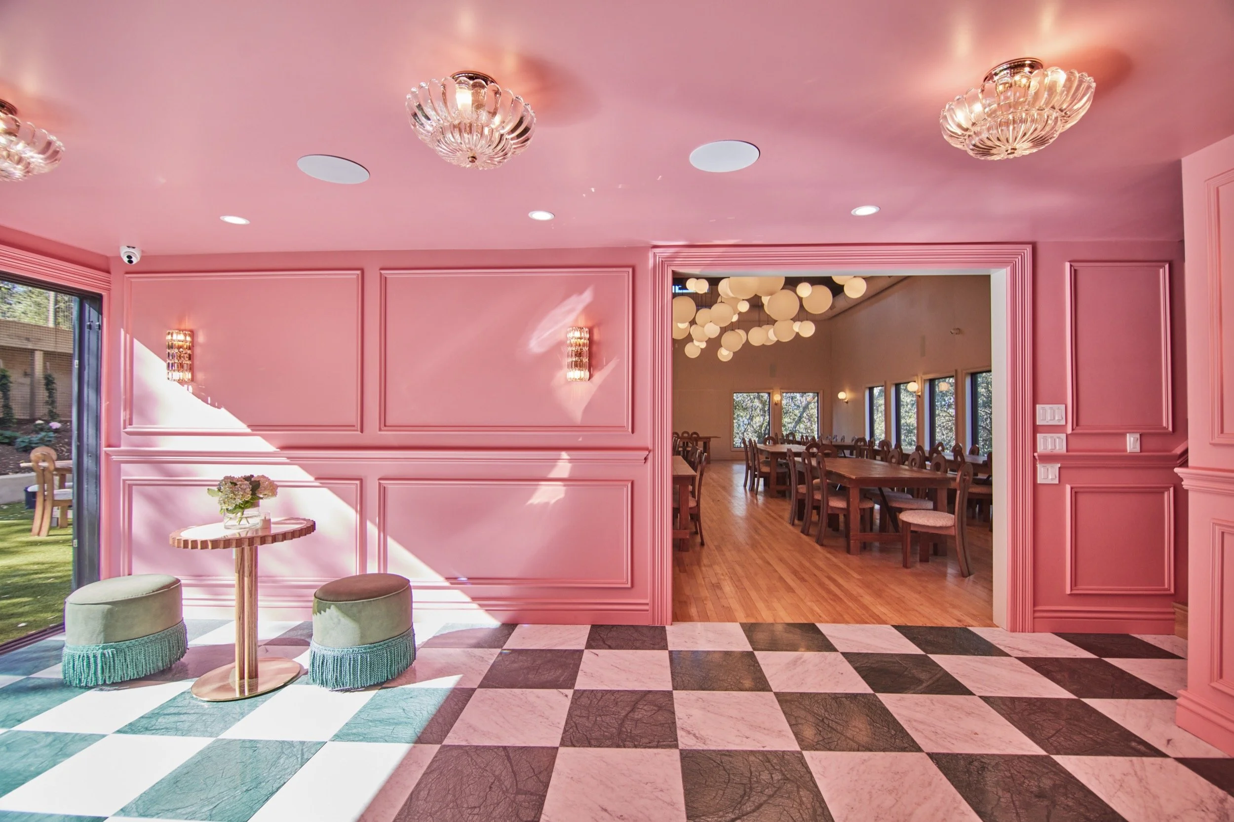 The pink bar's checkered floor, looking through to the lantern-lit Event Hall.
