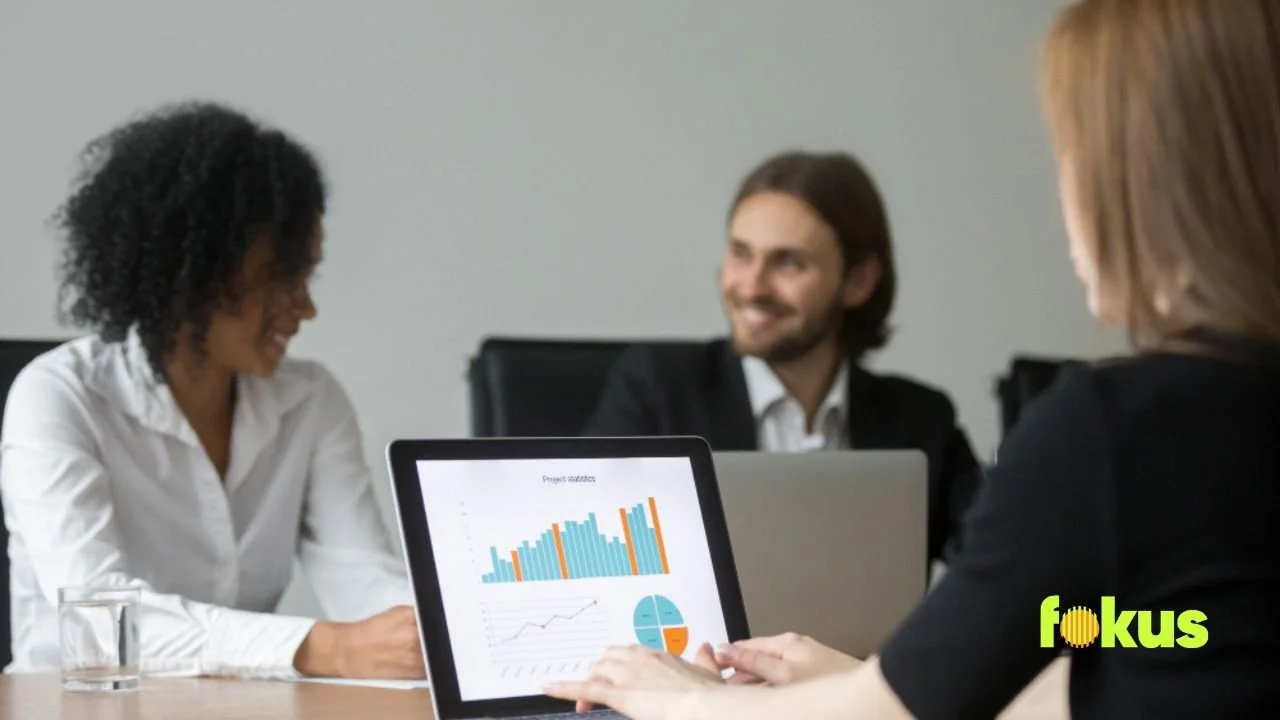 A woman in a meeting uses a tablet, focused on the topic "Measuring Success Without Overcomplicating It."