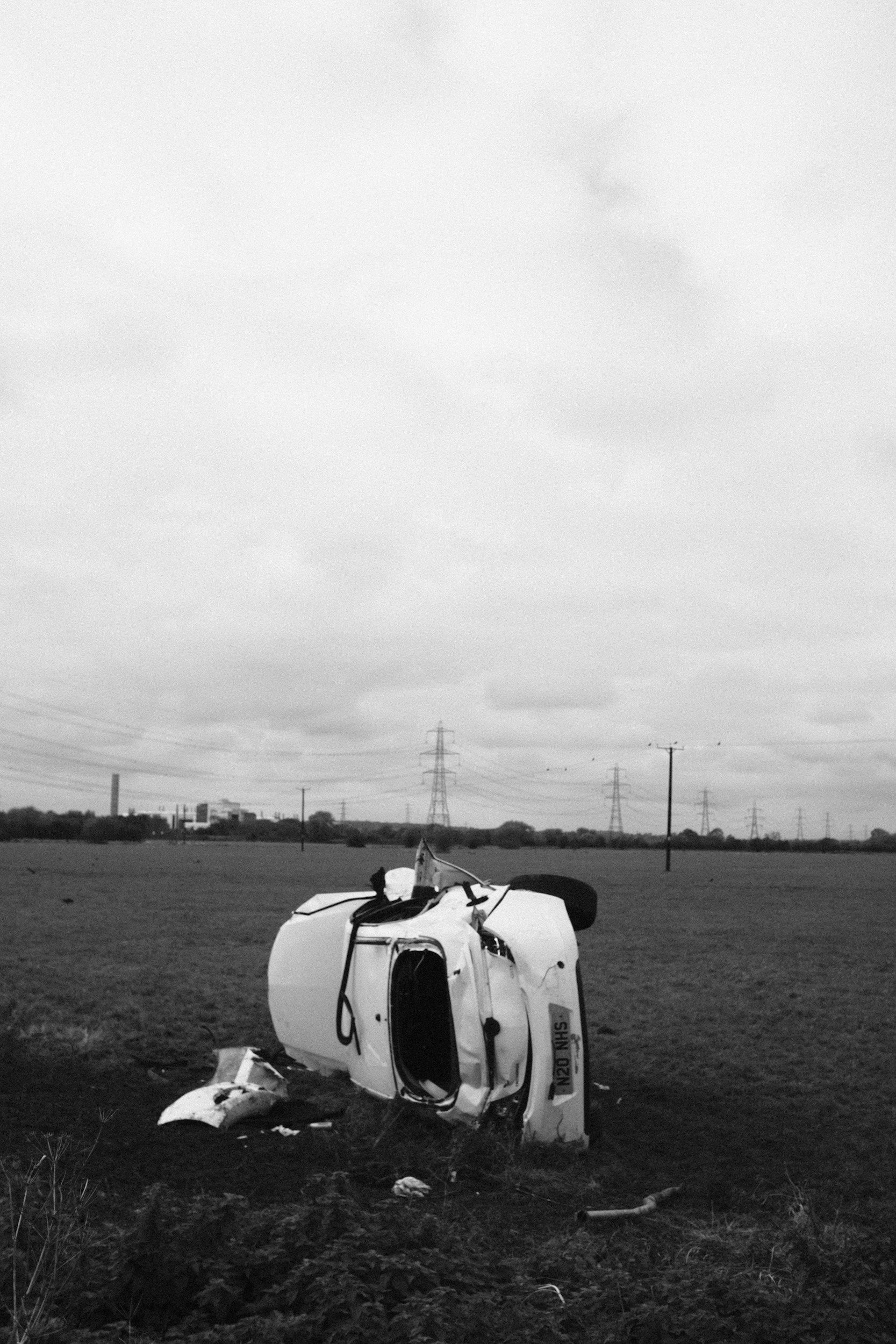 car crash in a field on its side