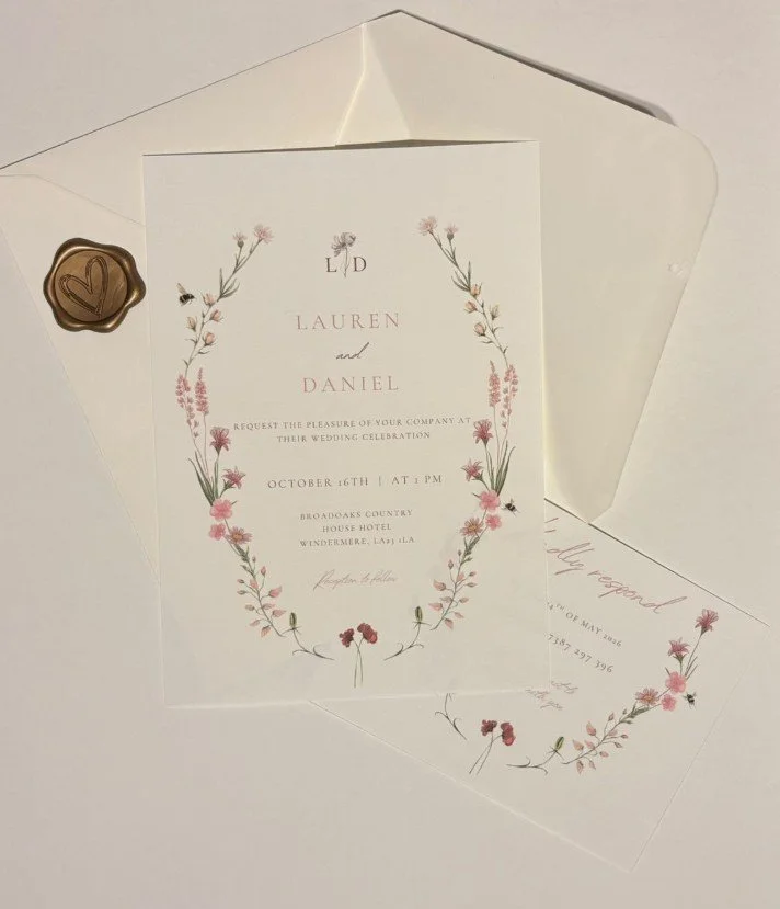 Wedding invitation card with floral border for Lauren and Daniel's wedding, scheduled on October 16th at 1 PM at Broadloops Country House Hotel.