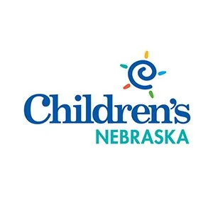 Children's Nebraska logo with a colorful spiral sun design.