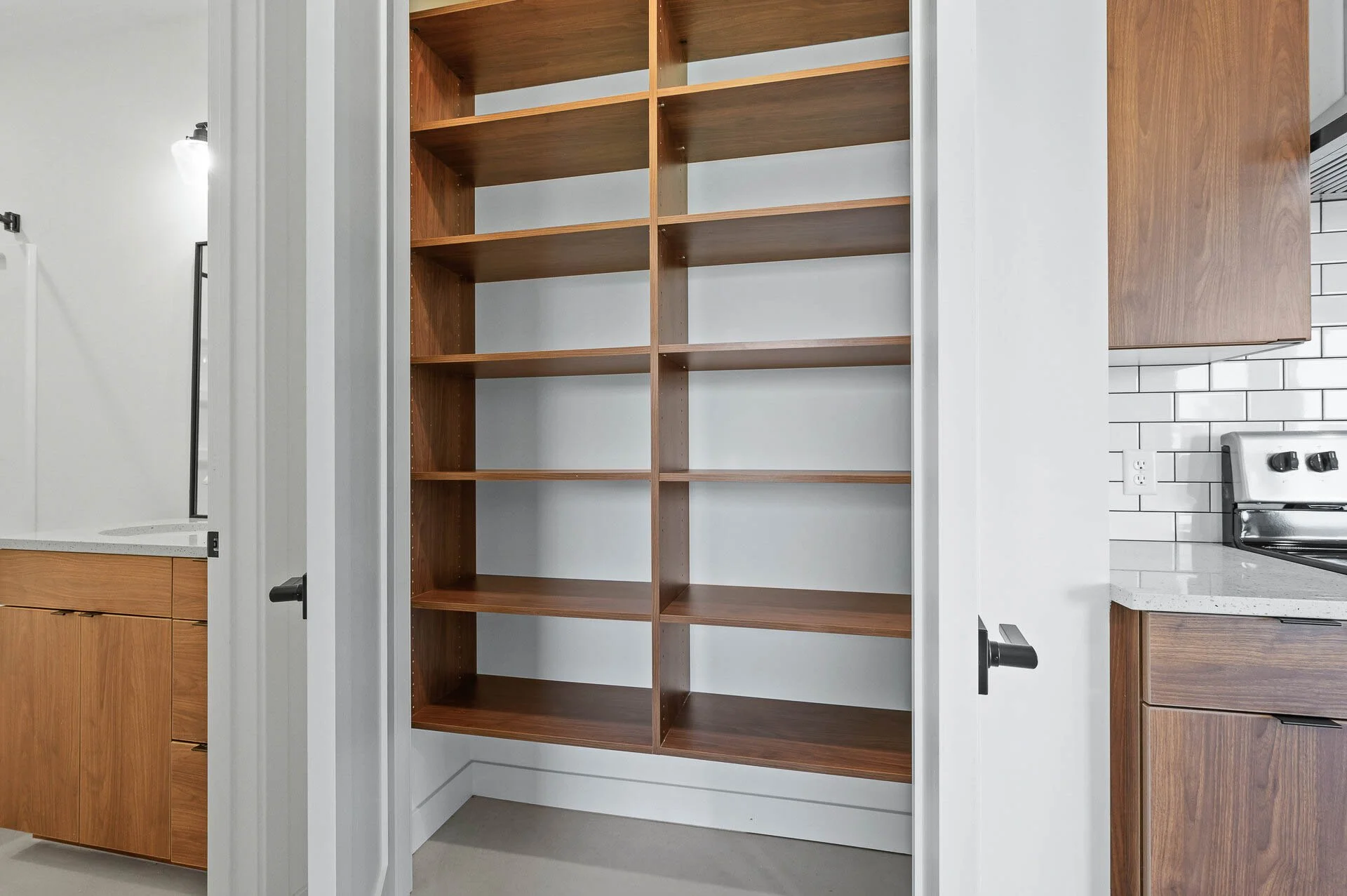 Empty wooden bookshelf in a kitchen closet.