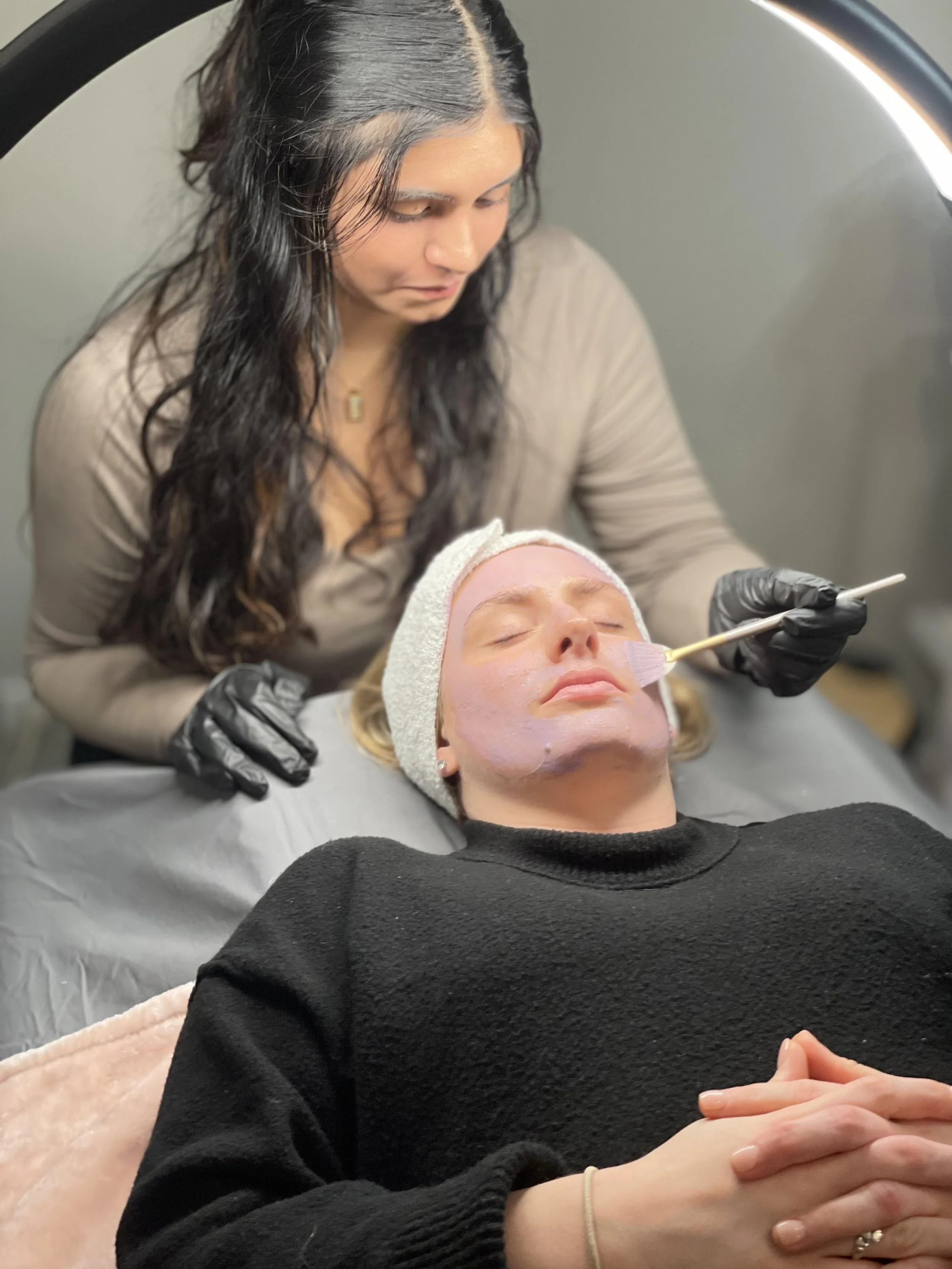 image of a facial being performed on client