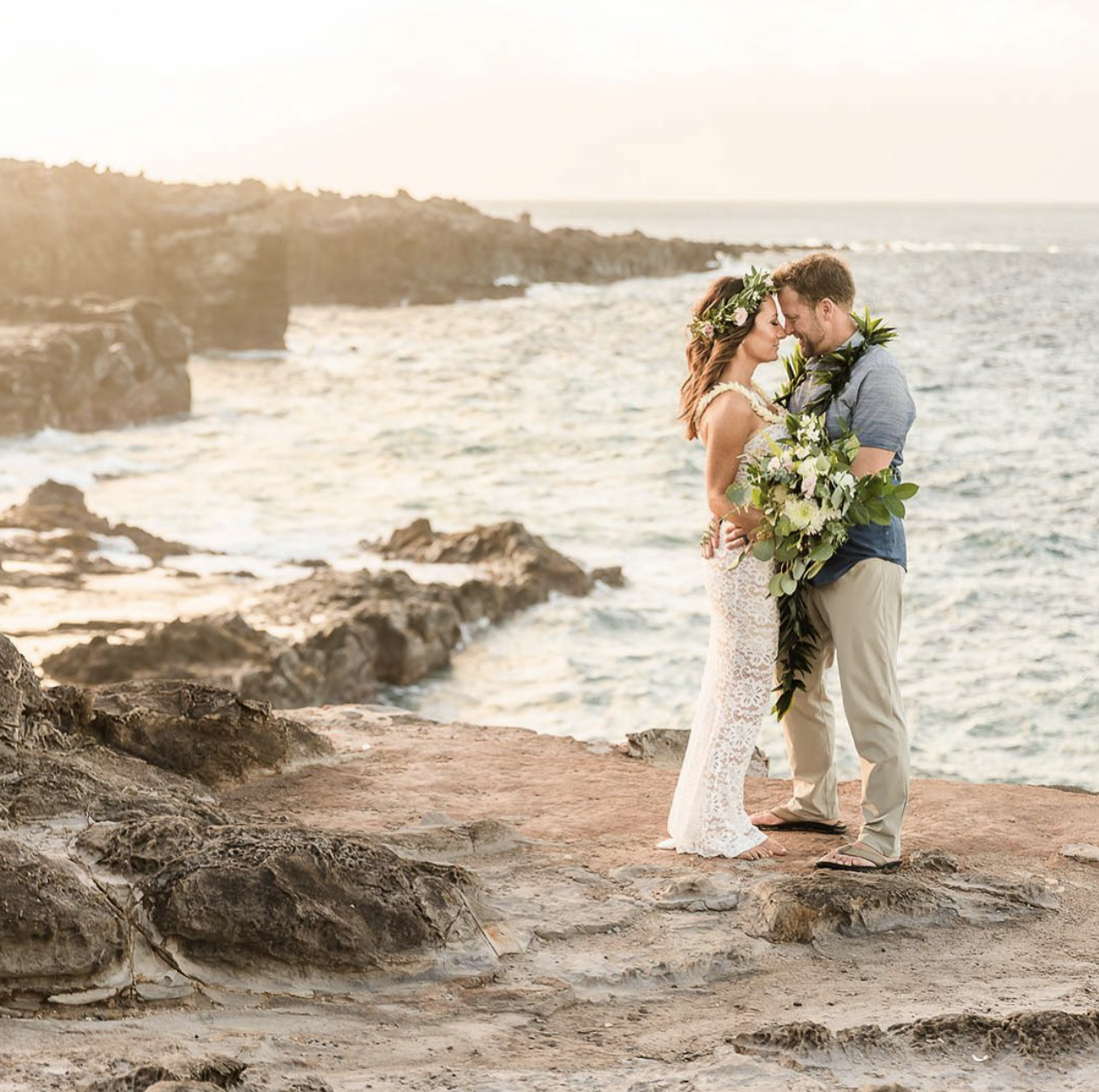 A couple eloping at Ironwoods Cliffs on Maui, with Haku lei and beach in the background