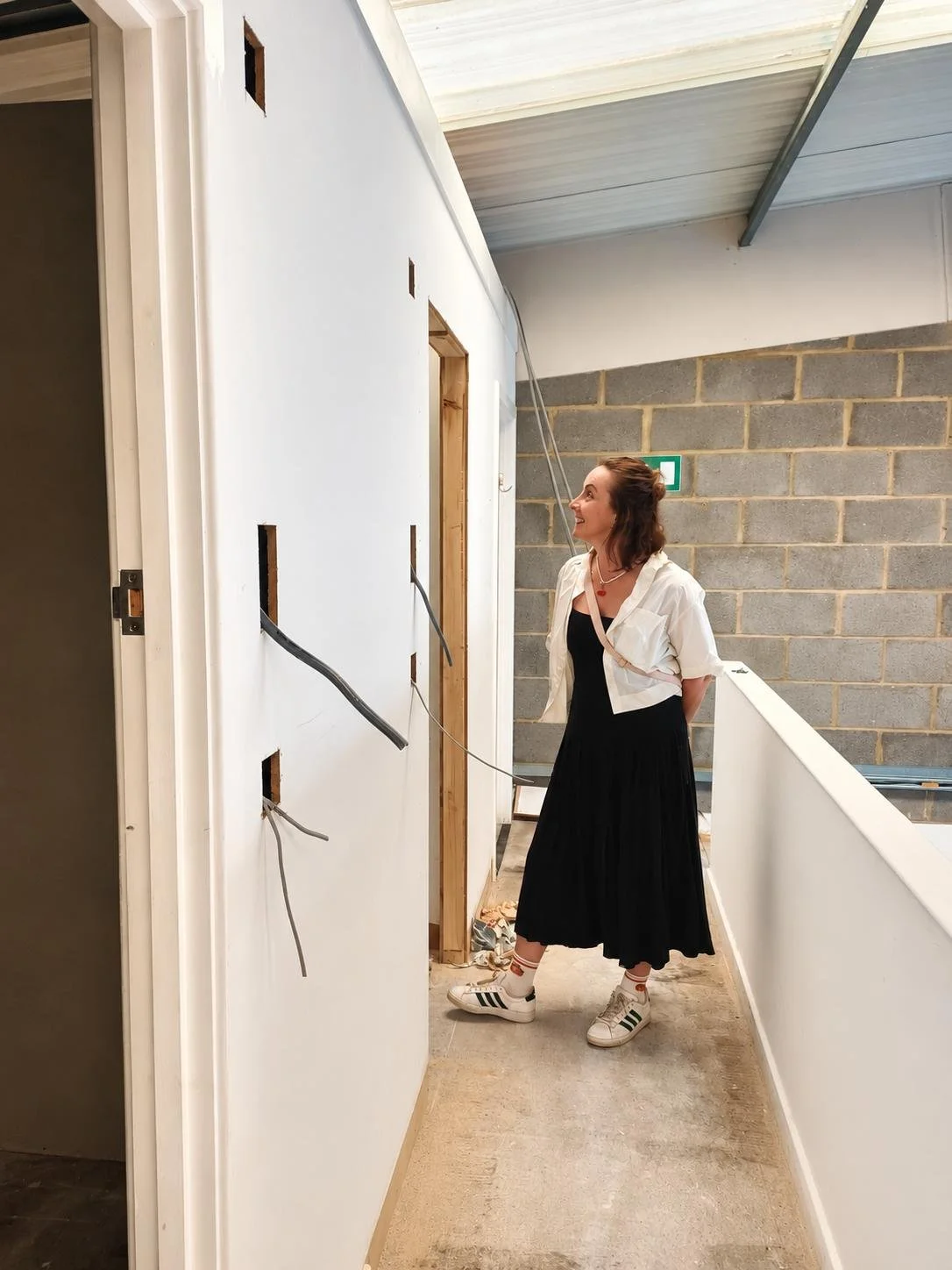 Women standing and looking inside the room