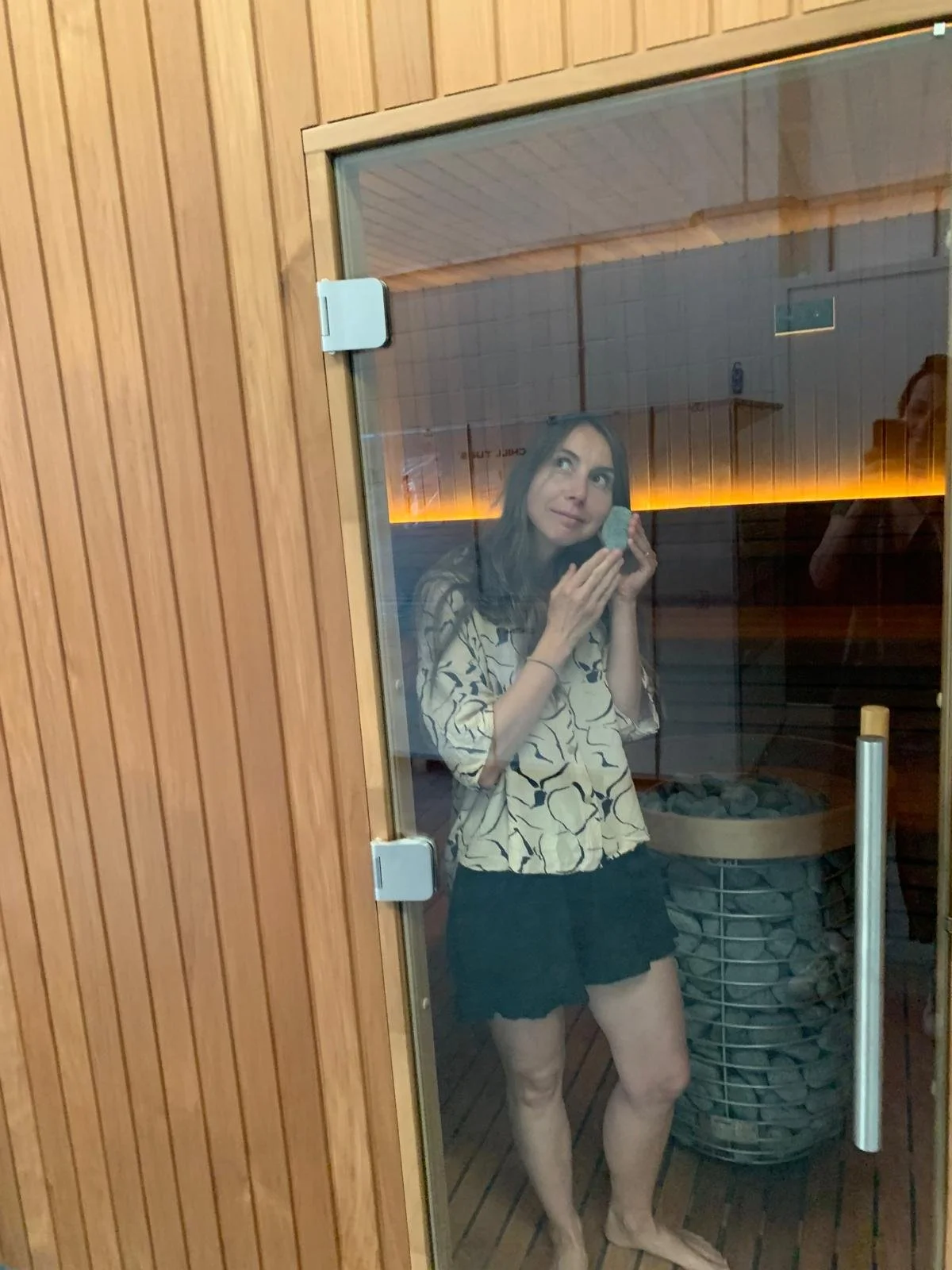 Women holding sauna stone