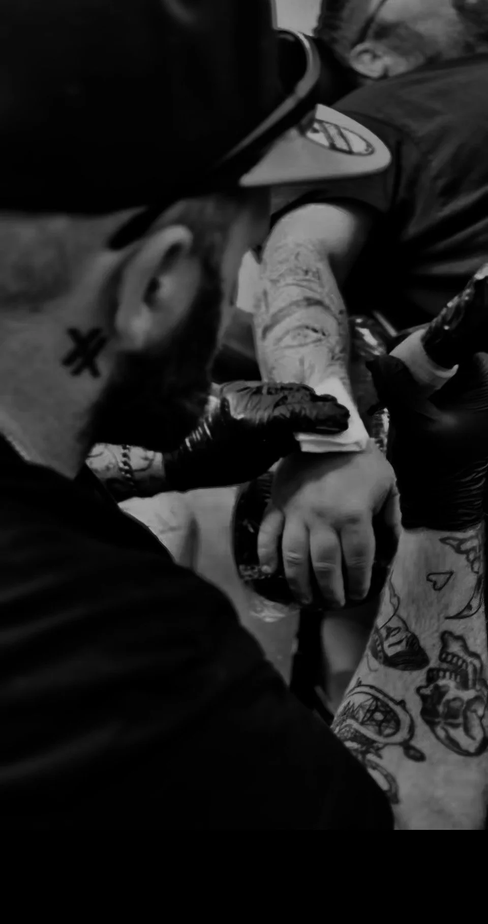 Tattoo artist Chandlier Harford in studio with his black and grey realism lion tattoo.
