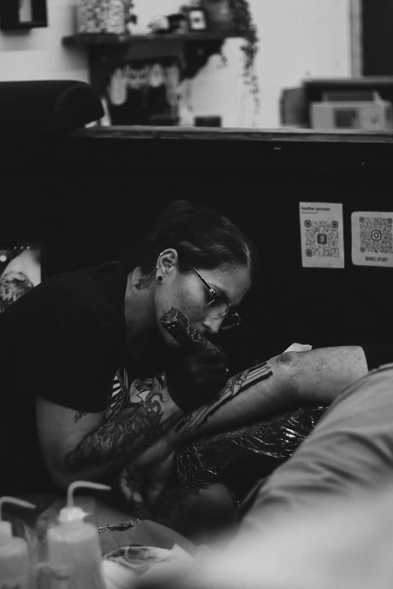 Heather tattooing the back of a forearm.