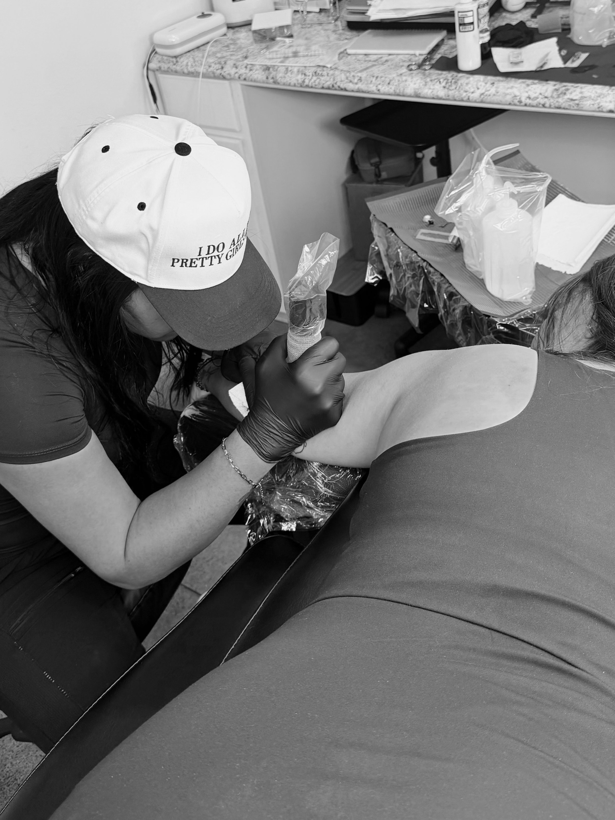 Tattoo artist Nancy tattooing eyeliner on a woman, with split image of close up of the eyeliner.