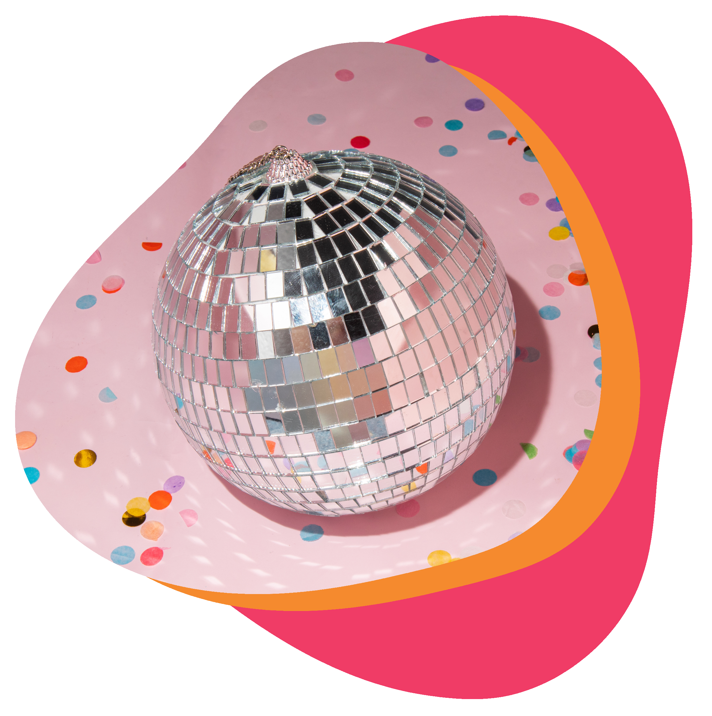 Small disco ball on pink paper with multicolored confetti scattered around.