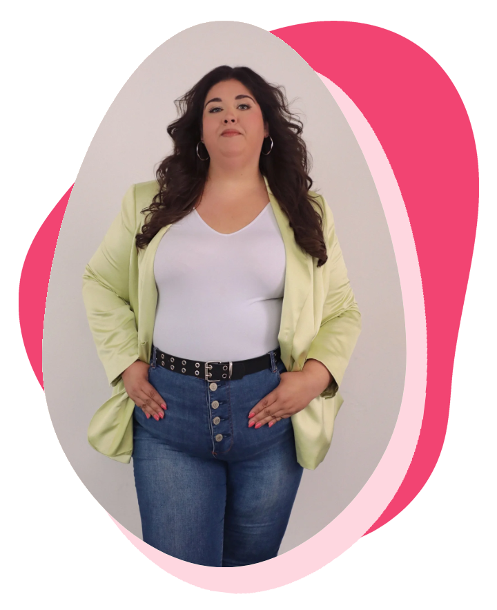 A woman with long curly dark hair wearing a white top, yellow blazer, and blue jeans, posing against a plain background with pink and white graphic overlays.