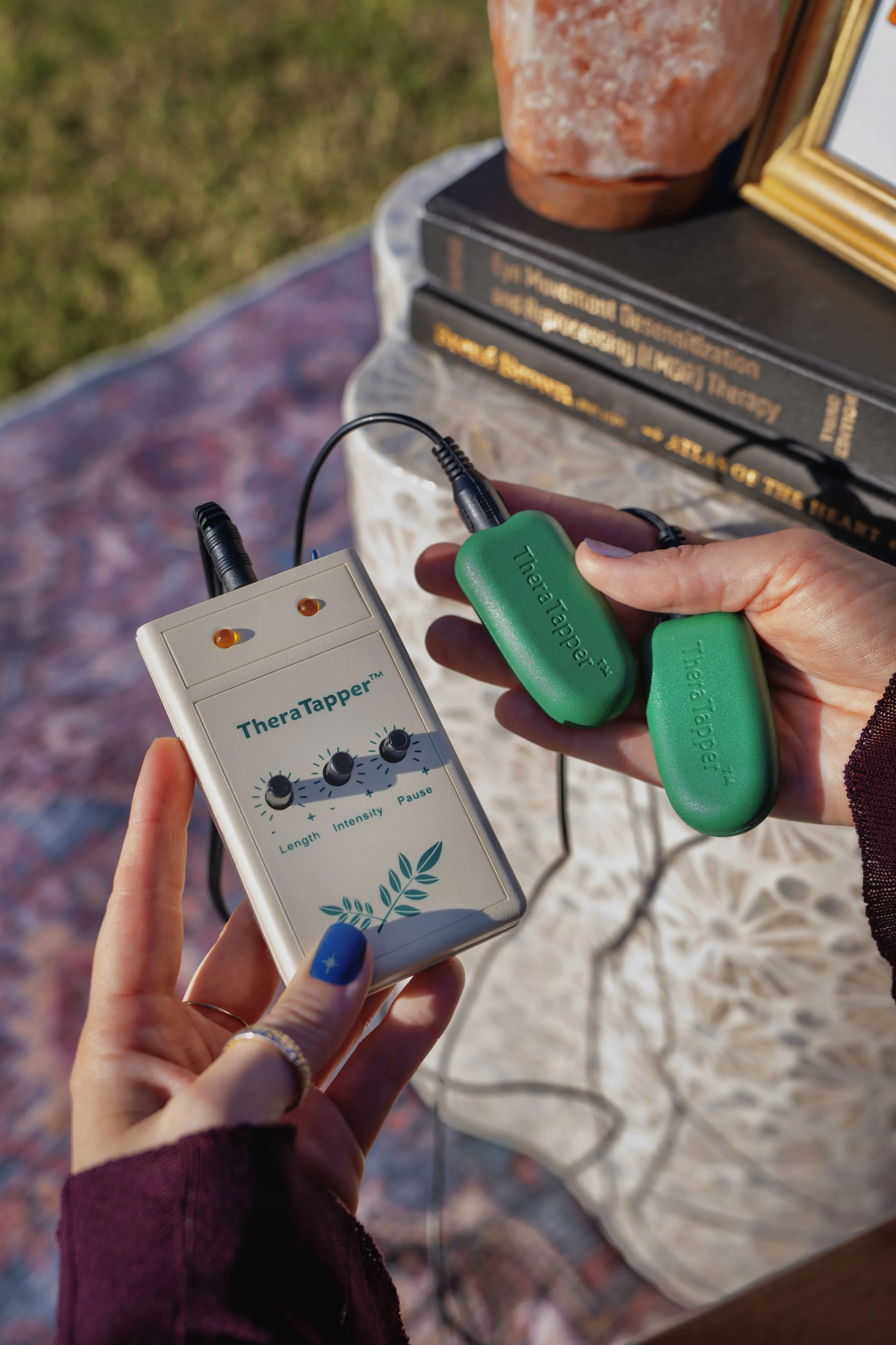 Therapist showing Eye Movement Desensitization and Reprocessing (EMDR) TheraTapper device that stimulates Bi-lateral stimulation for emotional healing and trauma/PTSD.