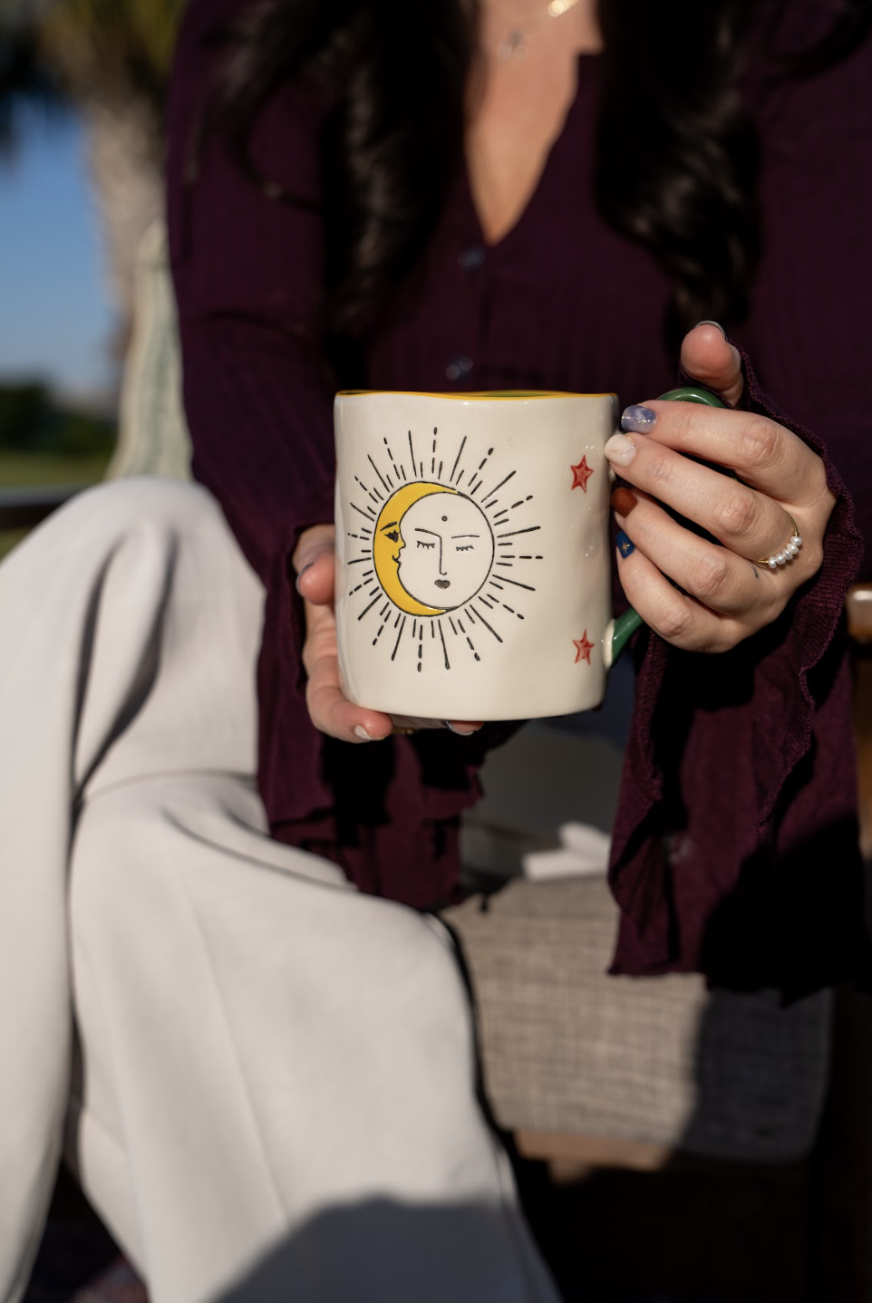 Therapist showing a mug, displaying compassion and warmth. Located in Mt. Pleasant, SC, overlooking the Ravenel Bridge.