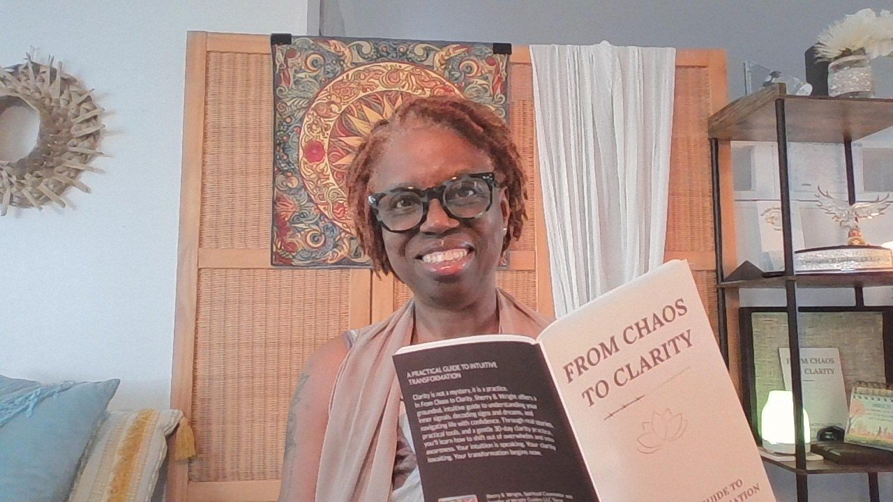 Sherry Wright, Army veteran and author, holding From Chaos to Clarity book for caregivers and military spouses.
