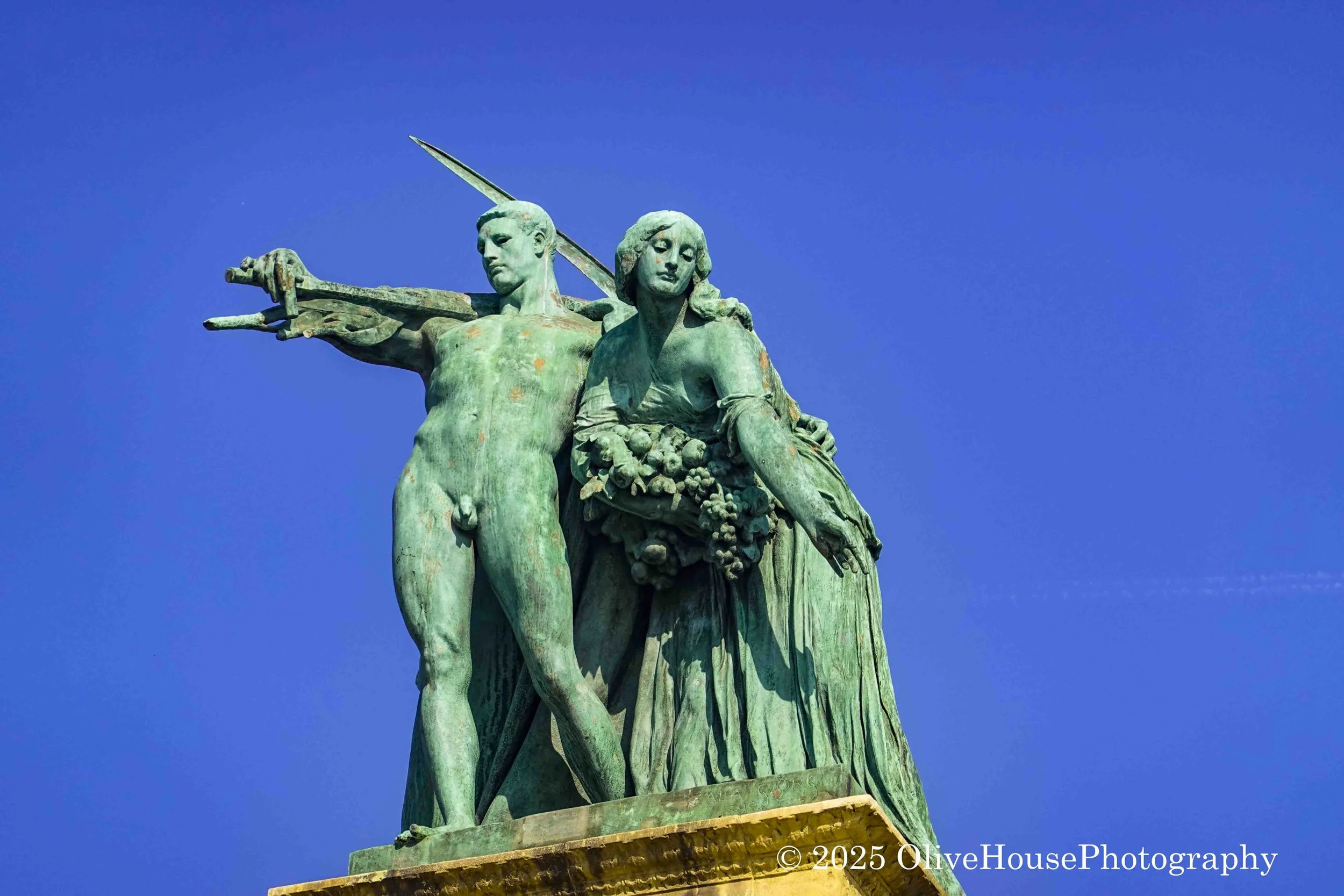 Statue depicting the allegorical figures of Labour and Wealth, located at the Millennium Monument in Heroes' Square, Budapest, Hungary. 