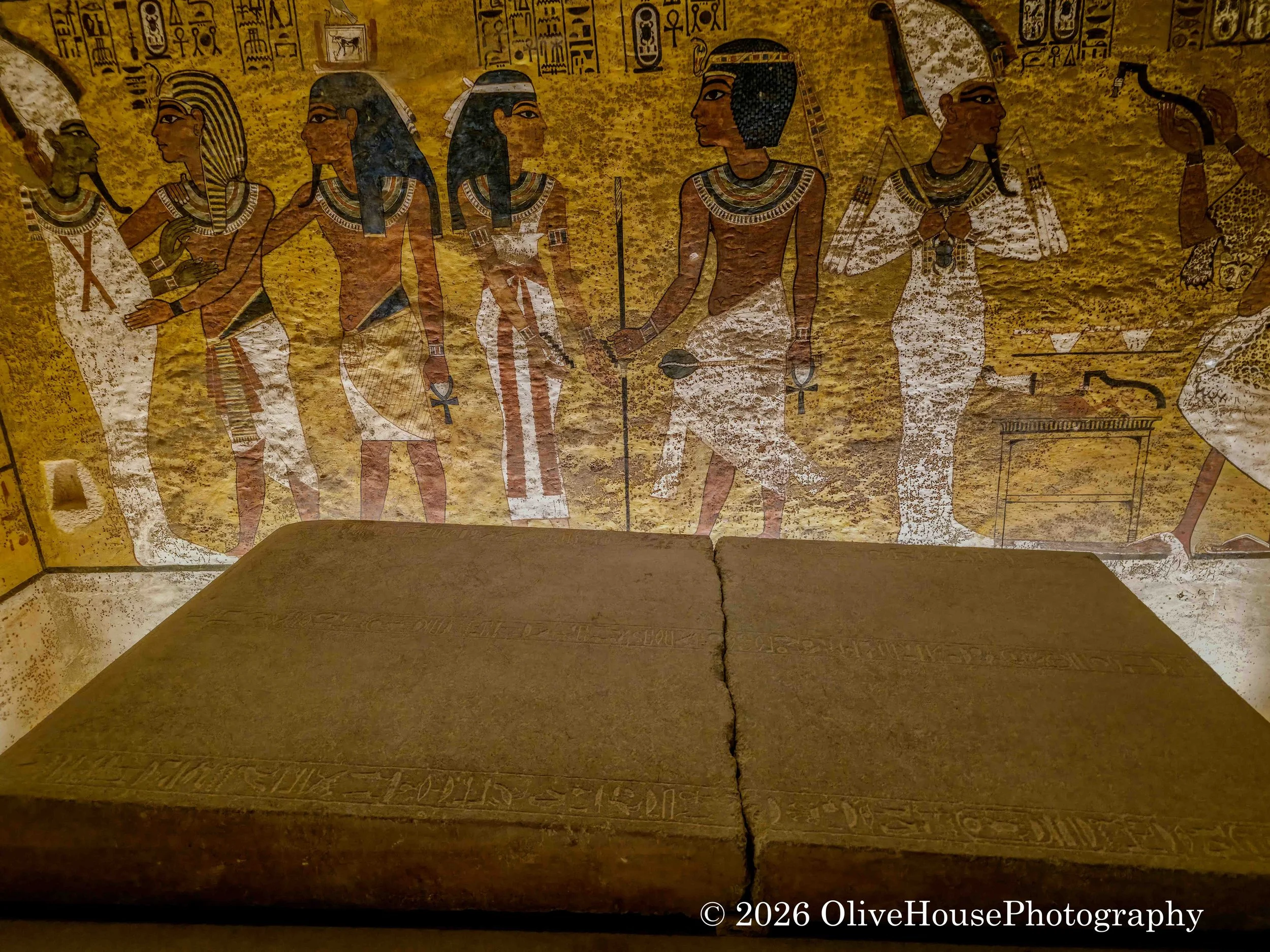 Painted walls and a large stone sarcophagus inside the tomb of Tutankhamun located in the Valley of the Kings, Egypt. The tomb was discovered almost completely intact by archaeologist Howard Carter in 1922, offering unparalleled insight into 18th Dyn