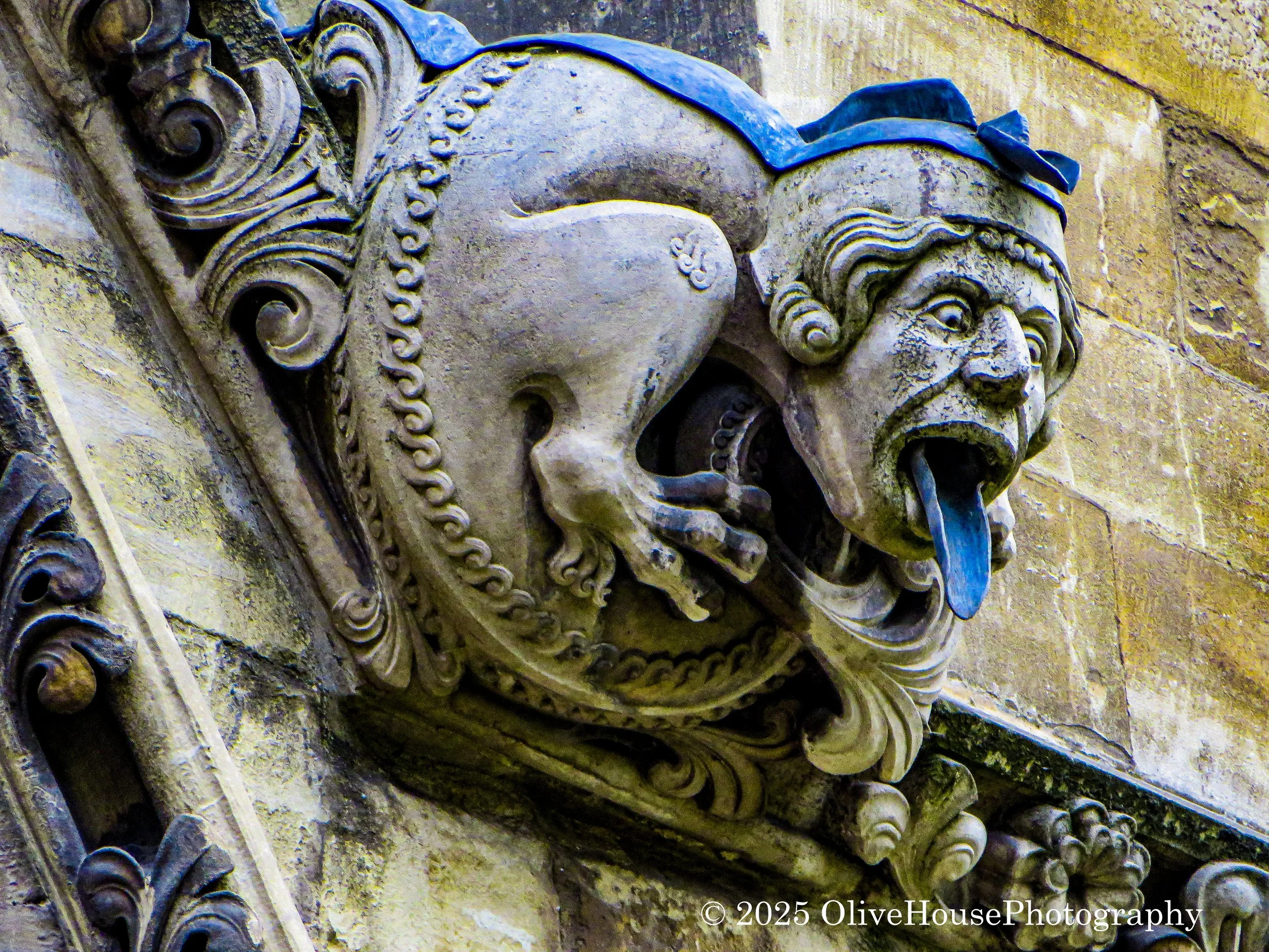 Gargoyle at Westminster Abbey in London England. A gargoyle is a carved or formed stone sculpture with a spout that drains rainwater away from a building's walls to prevent erosion, while a grotesque is purely decorative.